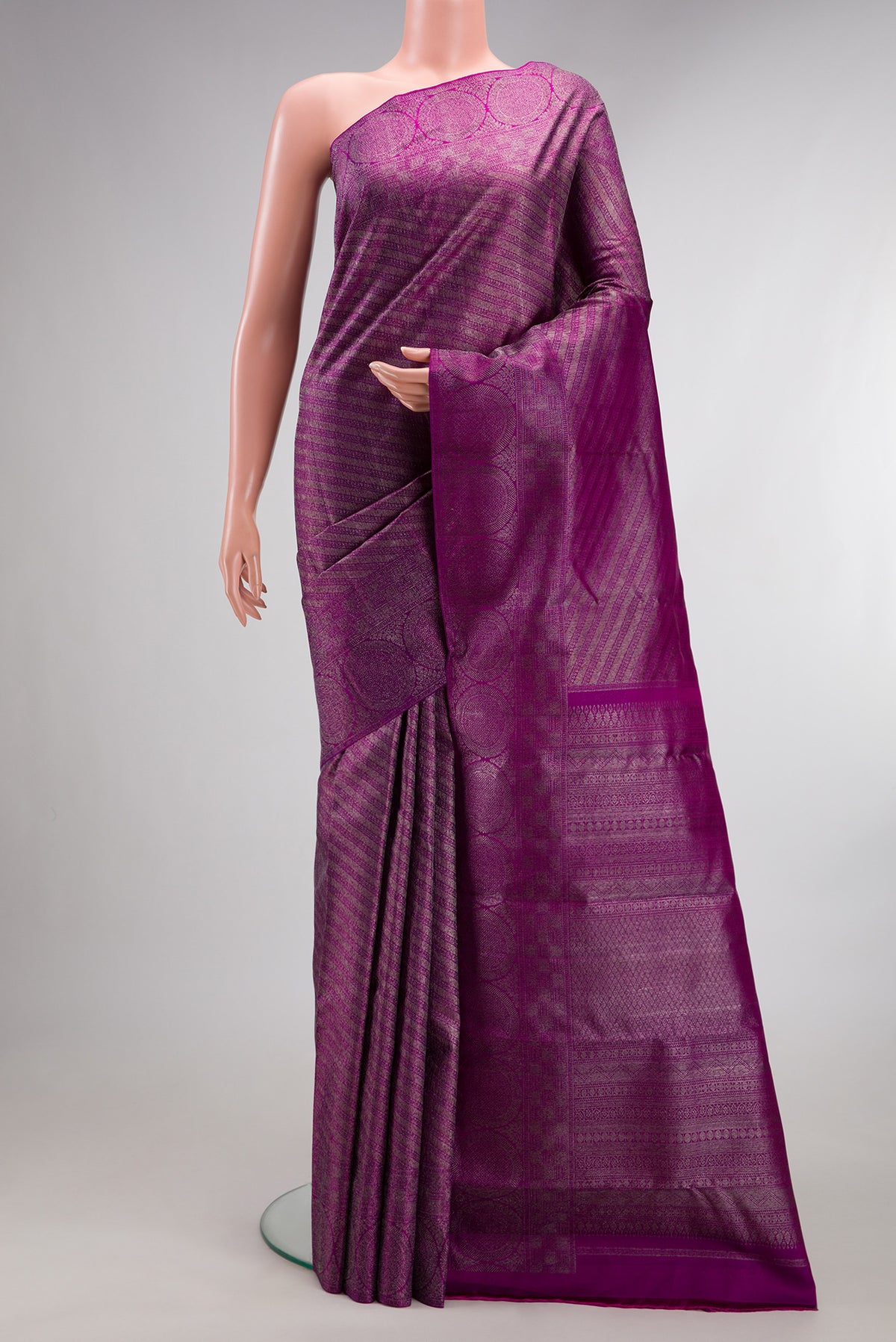 Pure Silk Magenta Kanjivaram Saree with Zari Brocade on the body and Zari Border.  displayed on a mannequin