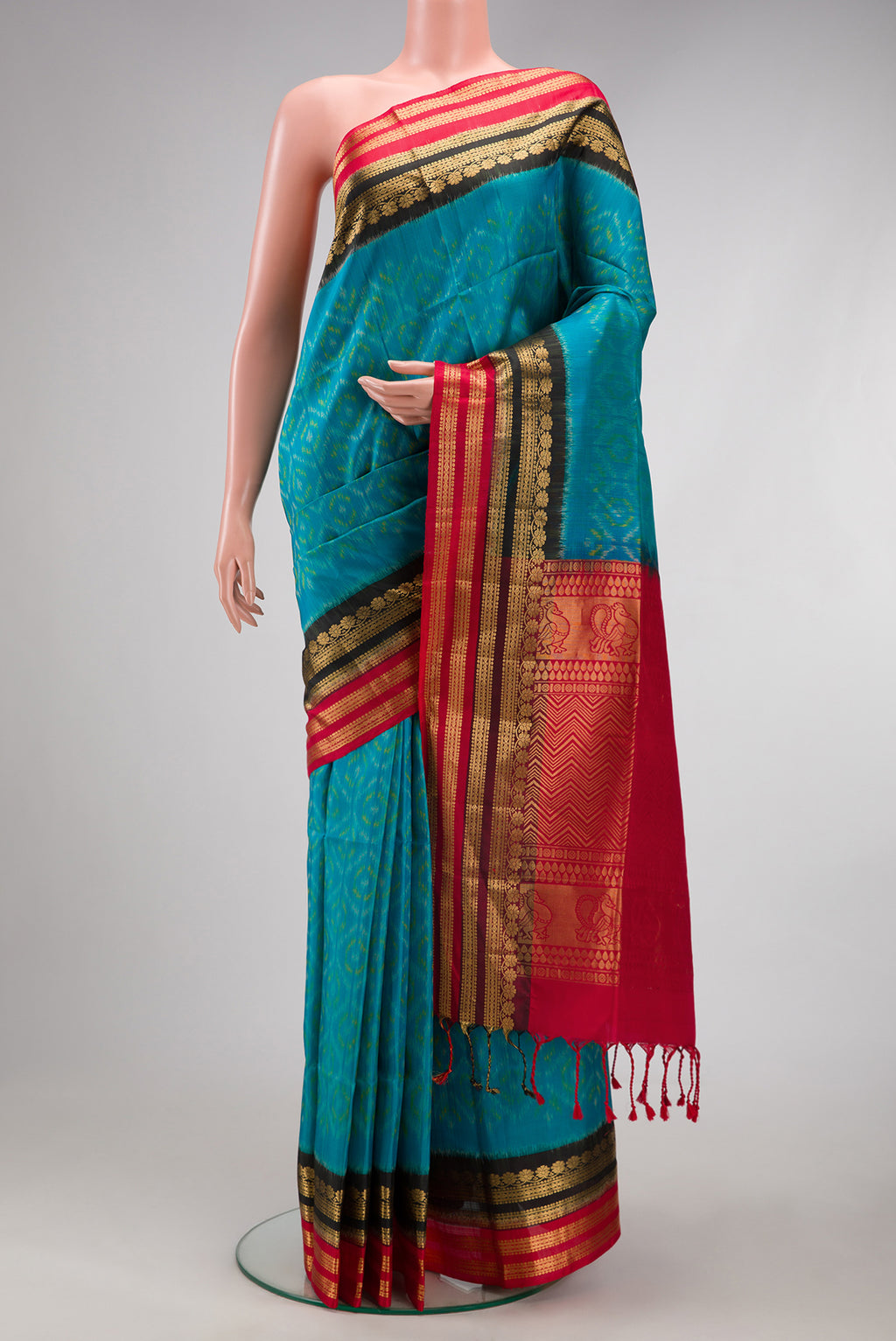 Sky Blue Soft Silk Saree with Ikat Print on the body and Fancy Border.  displayed on a mannequin