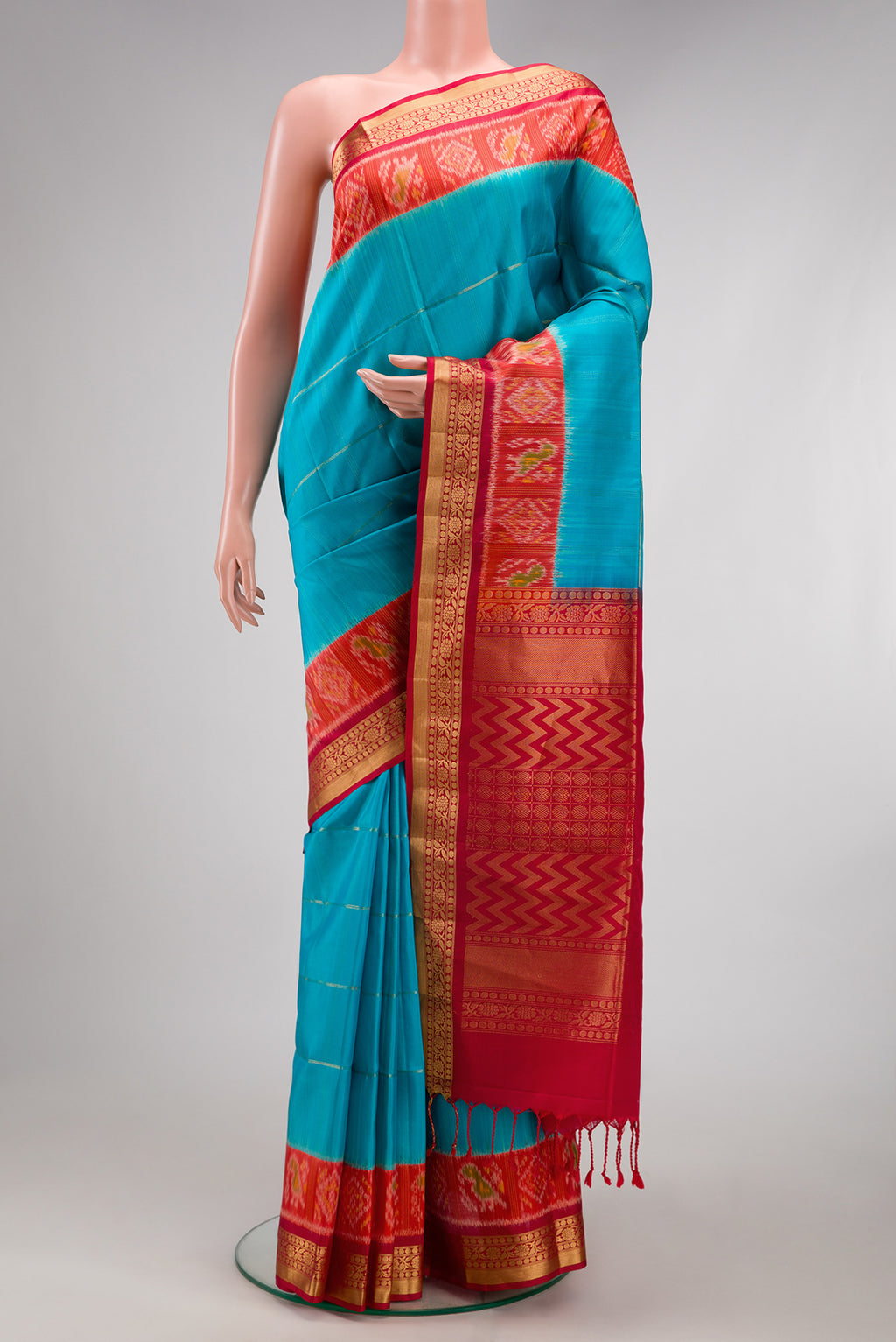 Sky Blue Soft Silk Saree with Checked design on the body and Ikat Border.  displayed on a mannequin