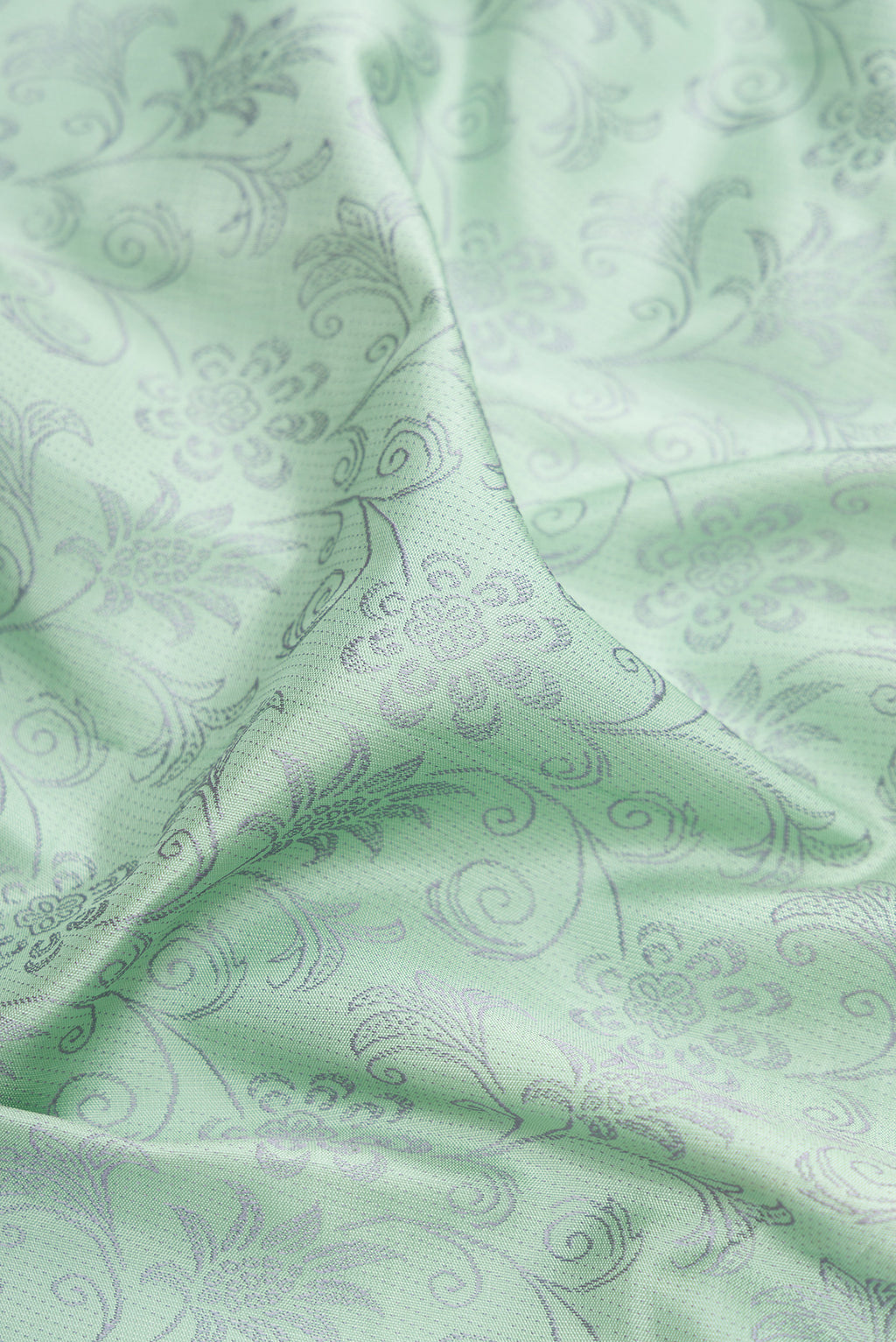 Close up of Light Green Kanchipuram Silk Saree with Jacquard design on the body and Fancy Border.  displaying folds