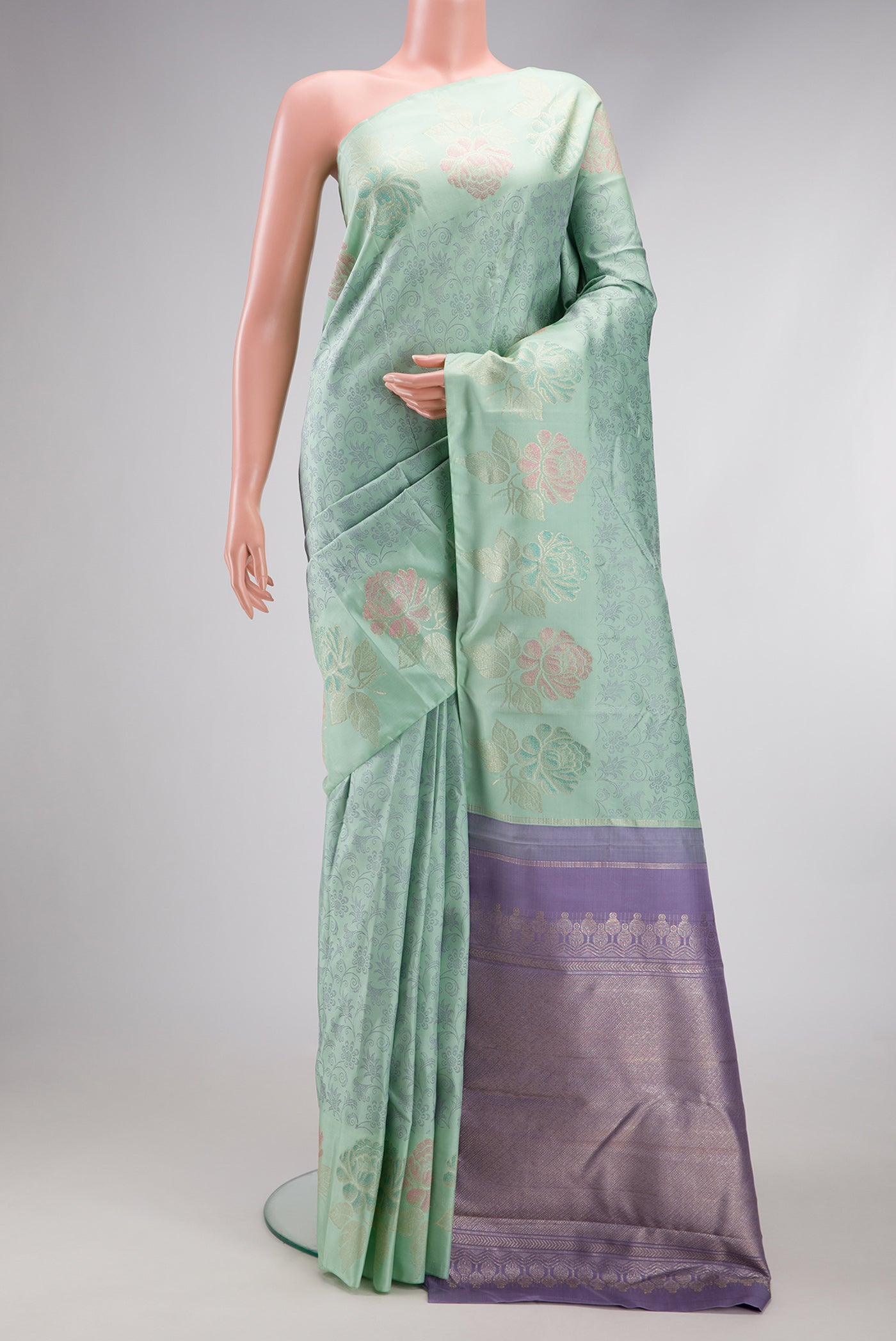 Light Green Kanchipuram Silk Saree with Jacquard design on the body and Fancy Border.  displayed on a mannequin