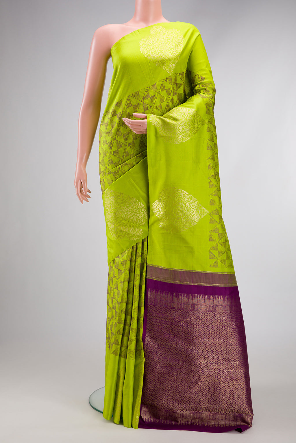 Parrot Green Kanjivaram Silk Saree with Jacquard design on the body and Fancy Border.  displayed on a mannequin