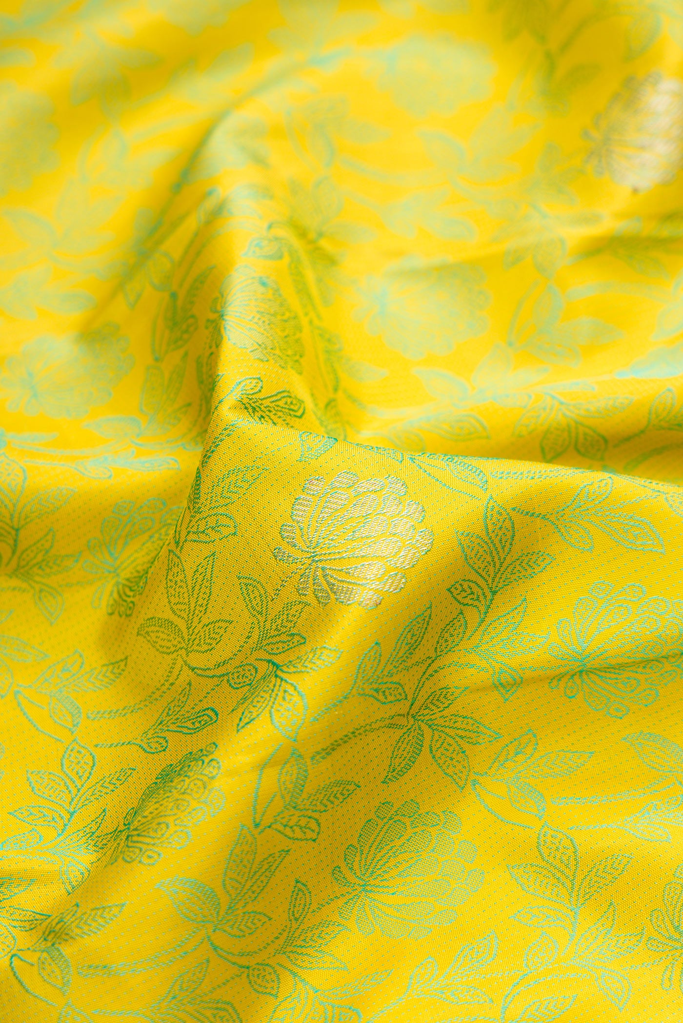 Close up of Lemon Yellow Kanjivaram Silk Saree with Jacquard design on the body and Fancy Border.  displaying folds