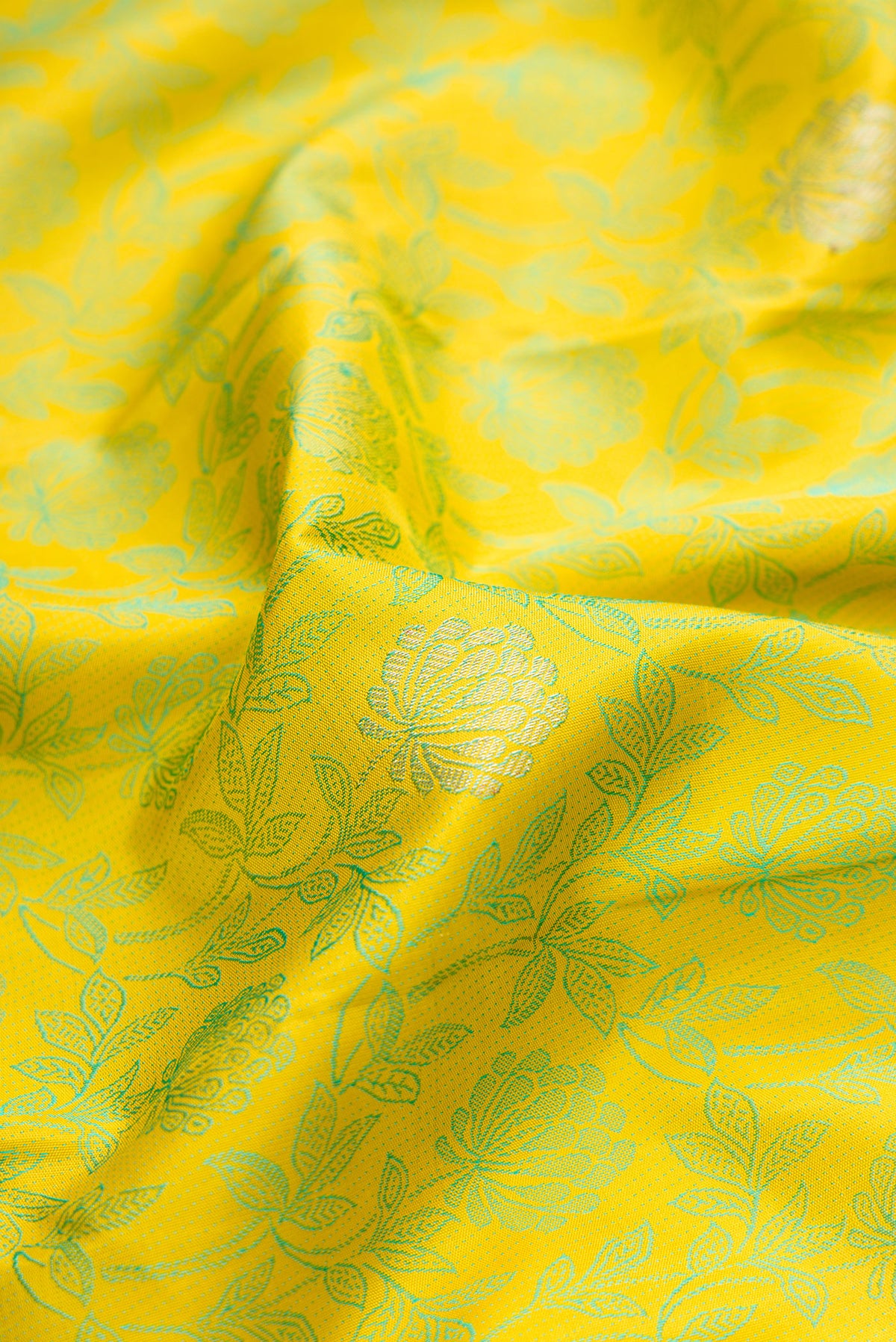 Close up of Lemon Yellow Kanjivaram Silk Saree with Jacquard design on the body and Fancy Border.  displaying folds