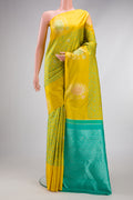 Lemon Yellow Kanjivaram Silk Saree with Jacquard design on the body and Fancy Border.  displayed on a mannequin