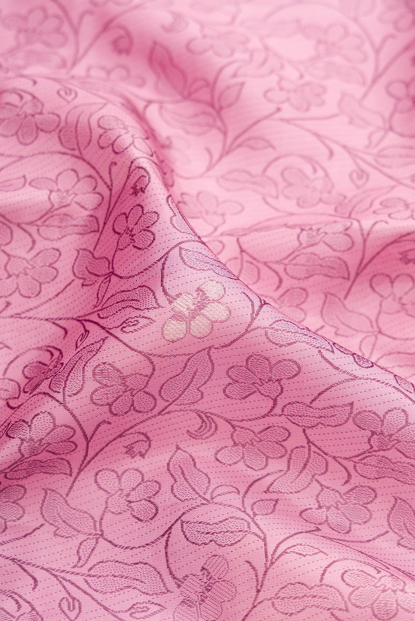 Close up of Pink Kanjivaram Silk Saree with Jacquard design on the body and Fancy Border.  displaying folds