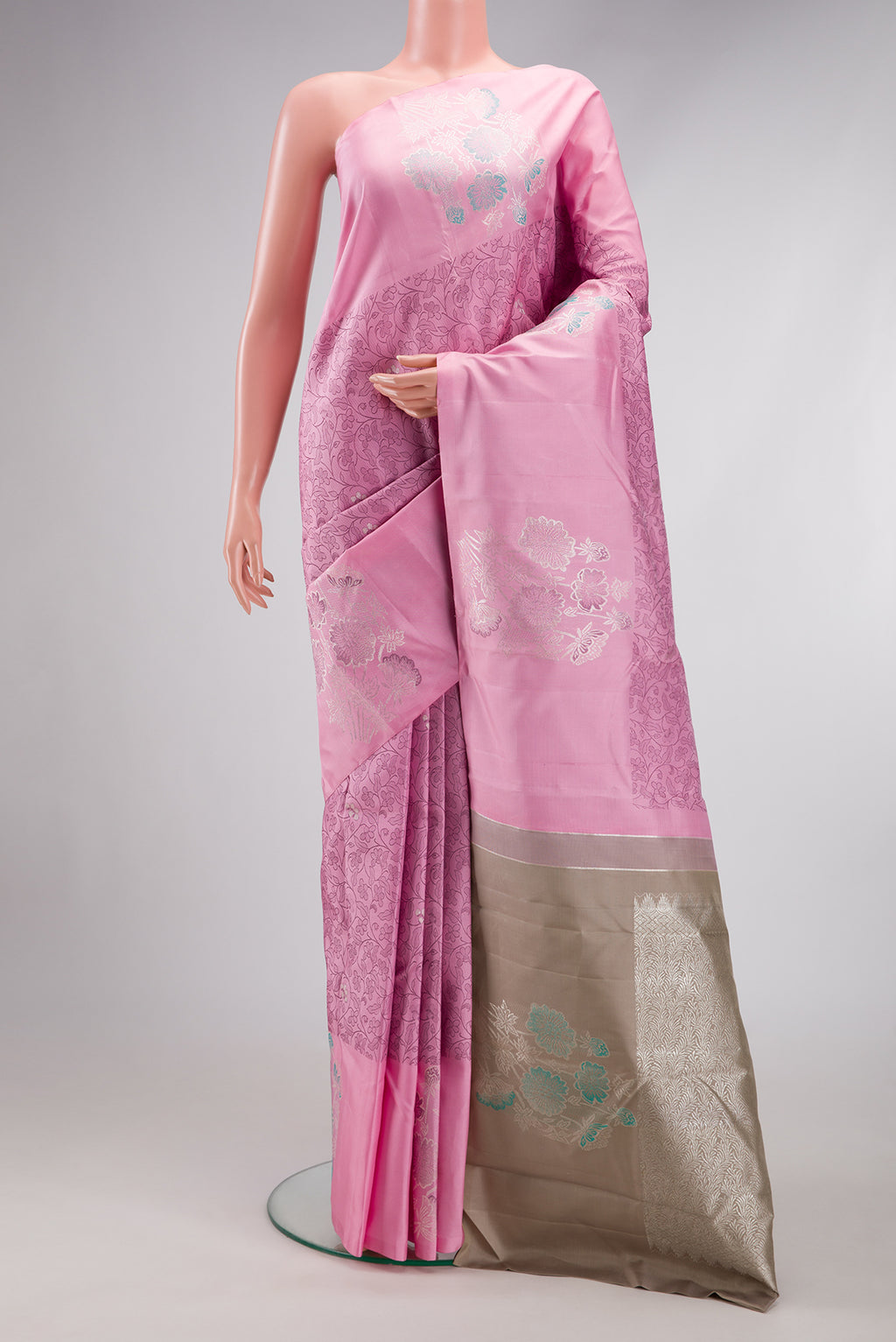Pink Kanjivaram Silk Saree with Jacquard design on the body and Fancy Border.  displayed on a mannequin