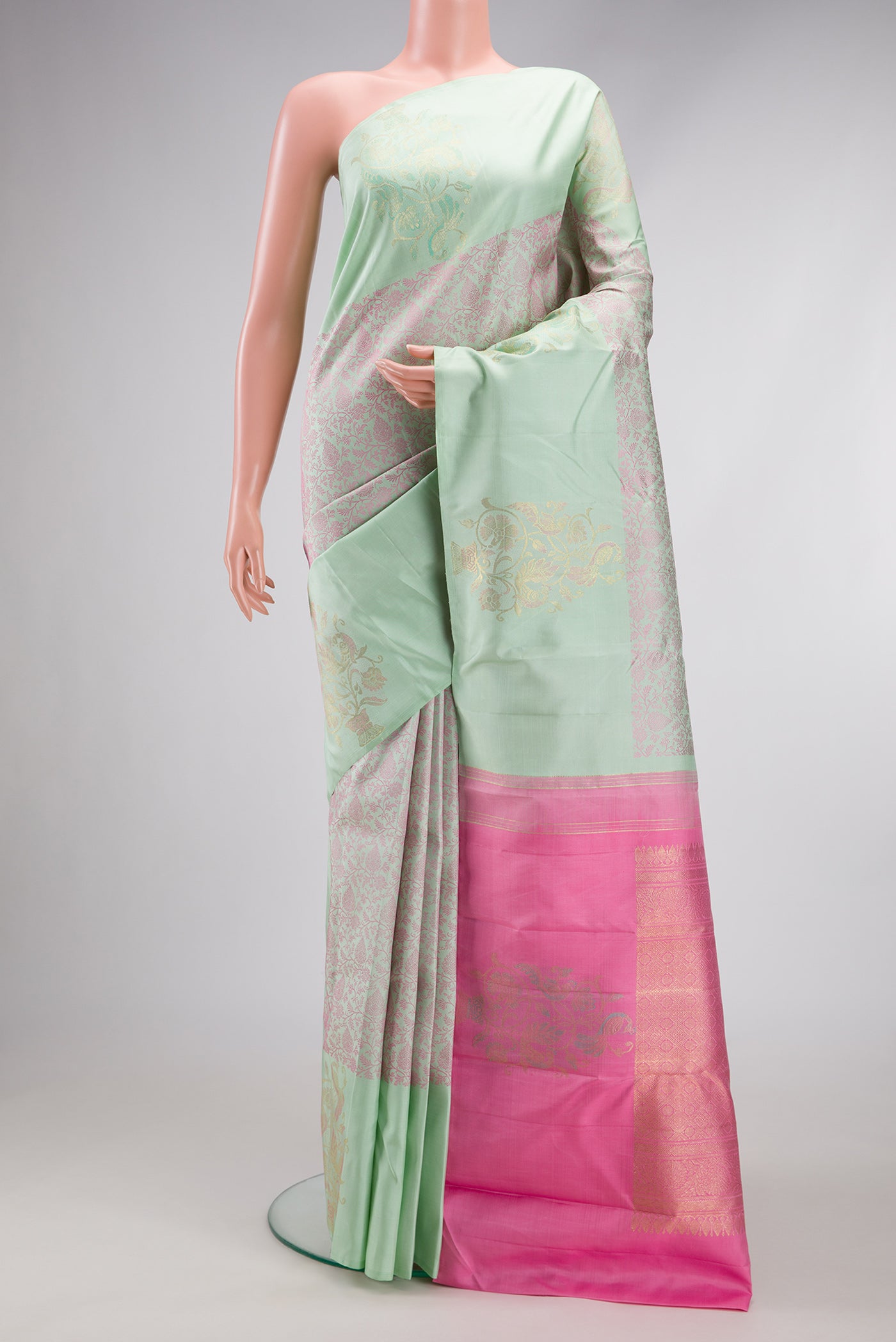 Light Green Kanjivaram Silk Saree with Jacquard design on the body and Fancy Border.  displayed on a mannequin