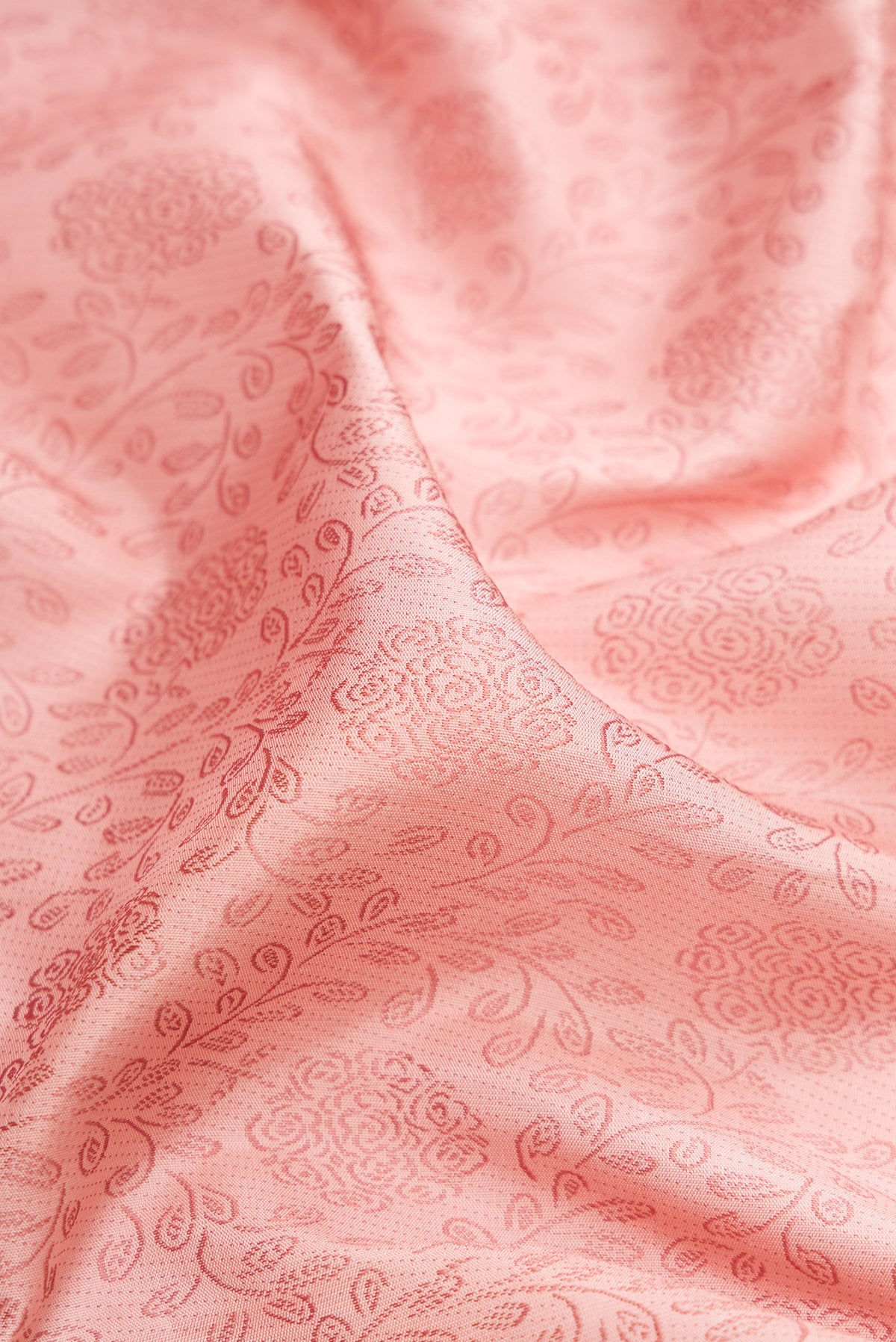 Close up of Peach Kanjivaram Silk Saree with Jacquard design on the body and Fancy Border.  displaying folds