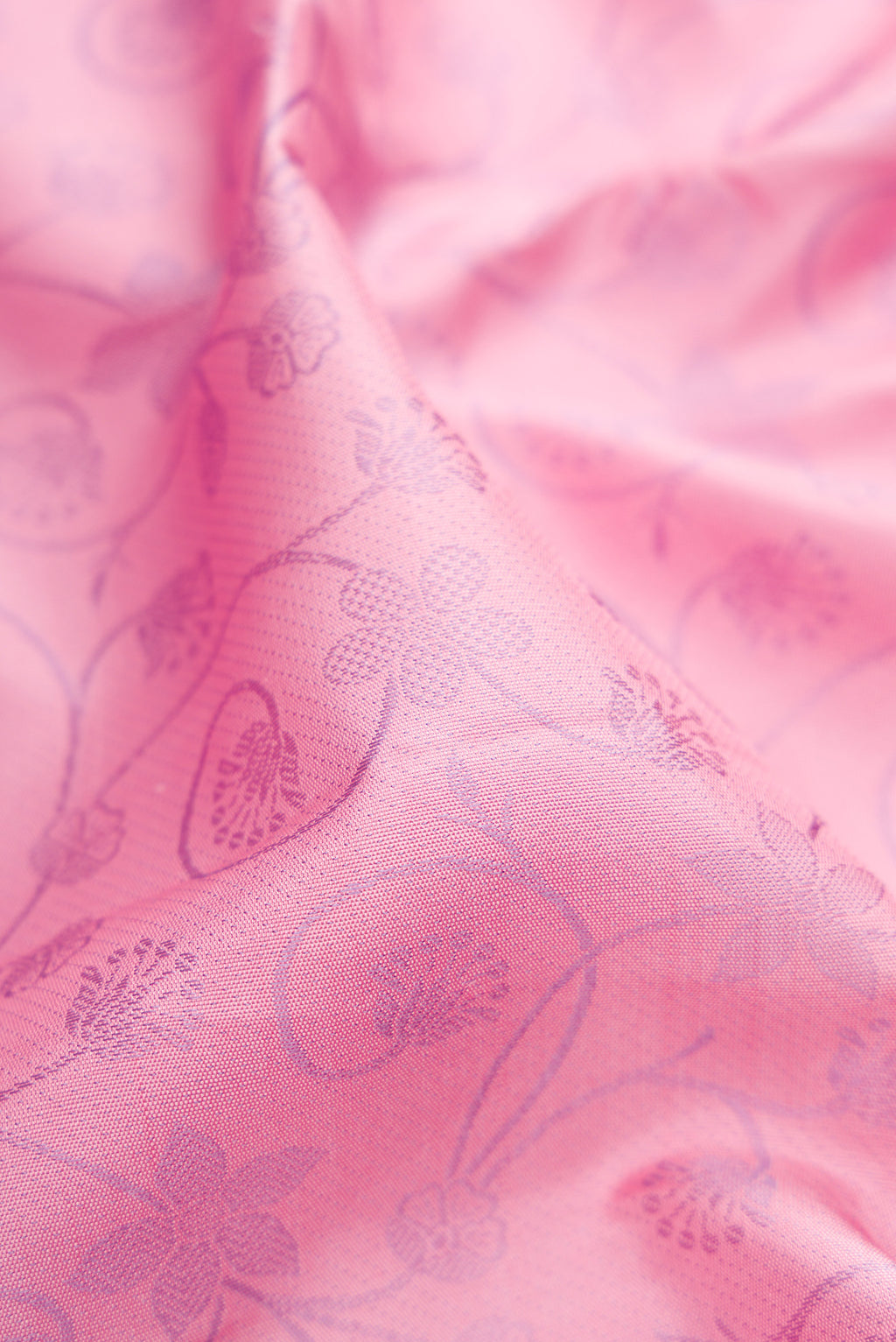 Close up of Pink Kanjivaram Silk Saree with Jacquard design on the body and Fancy Border.  displaying folds