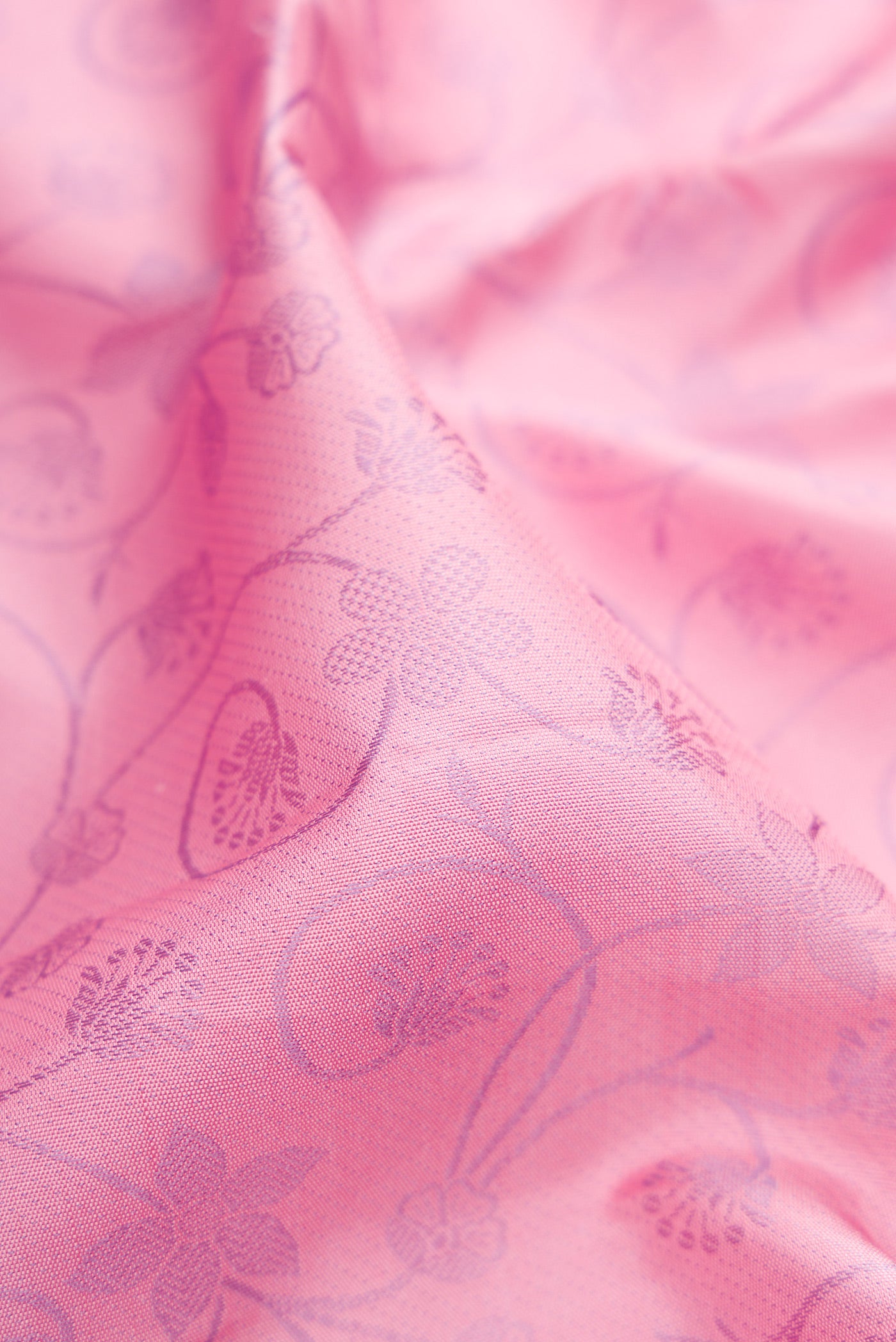 Close up of Pink Kanjivaram Silk Saree with Jacquard design on the body and Fancy Border.  displaying folds