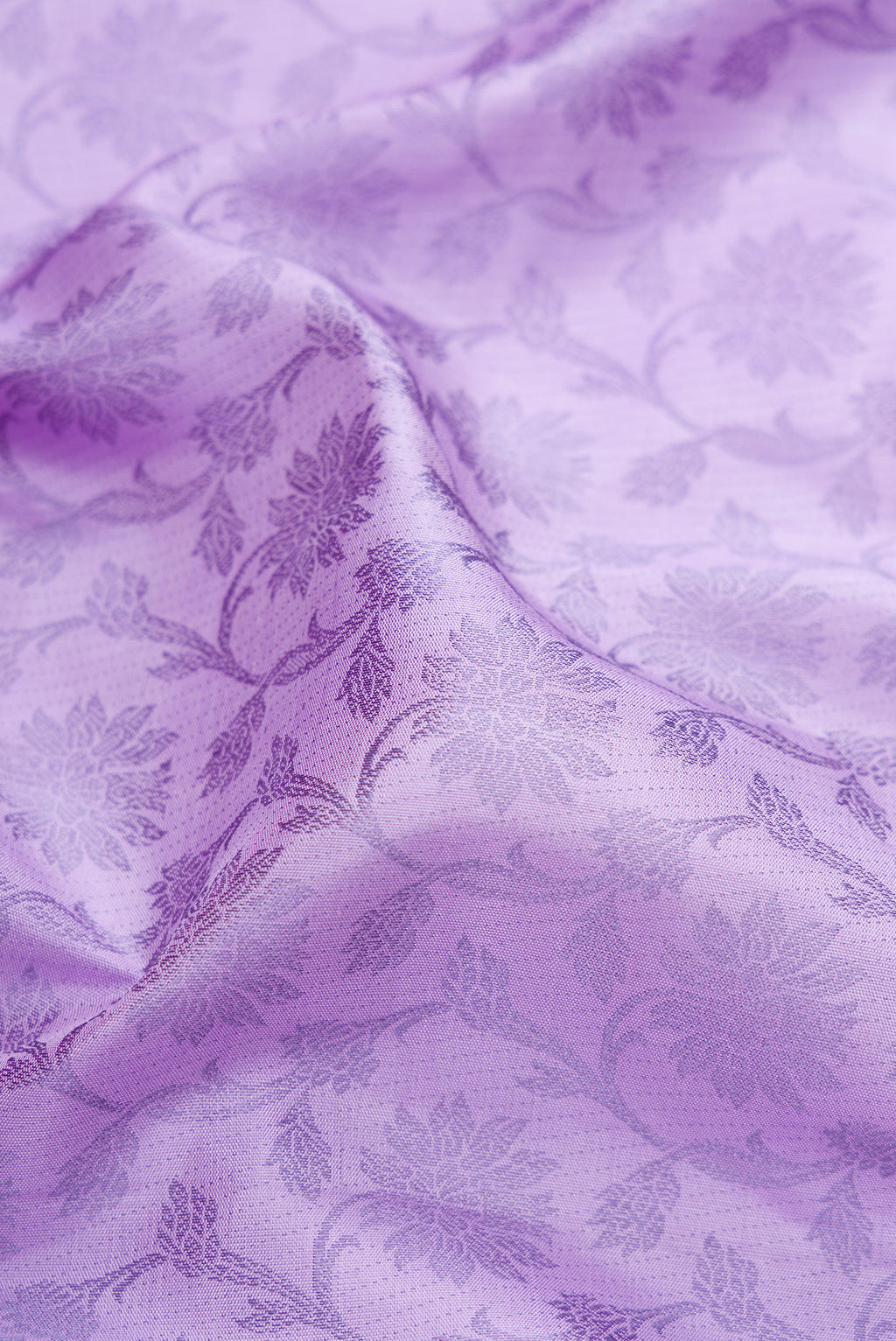 Close up of Lavender Kanjivaram Silk Saree with Jacquard design on the body and Fancy Border.  displaying folds