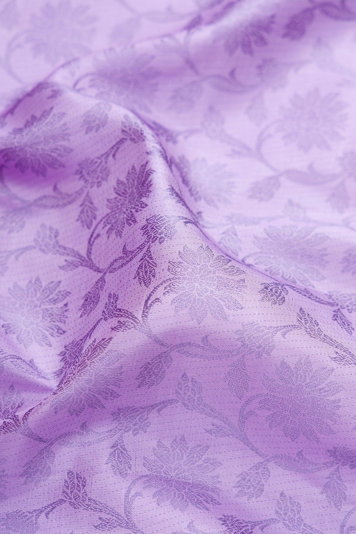 Close up of Lavender Kanjivaram Silk Saree with Jacquard design on the body and Fancy Border.  displaying folds