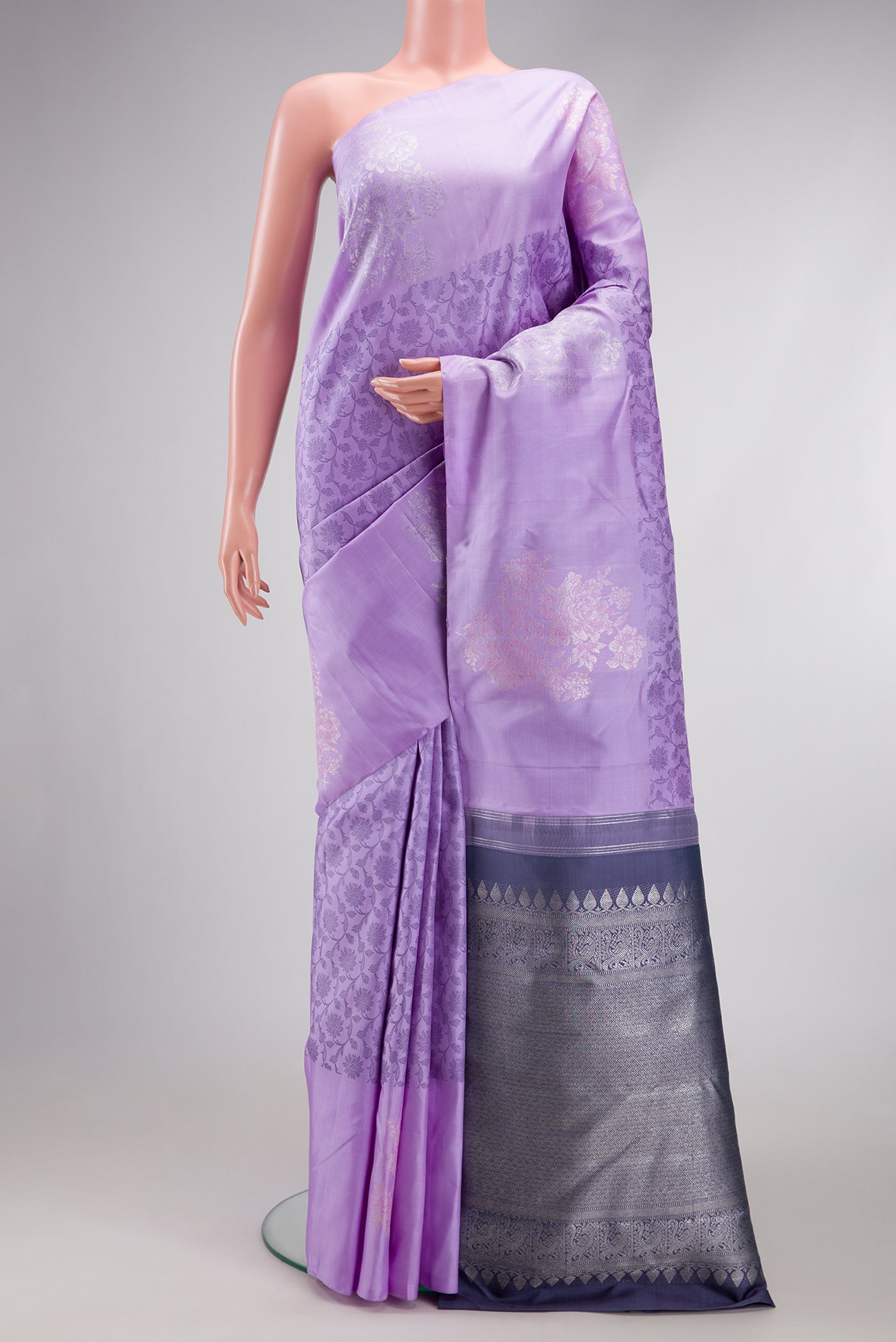 Lavender Kanjivaram Silk Saree with Jacquard design on the body and Fancy Border.  displayed on a mannequin