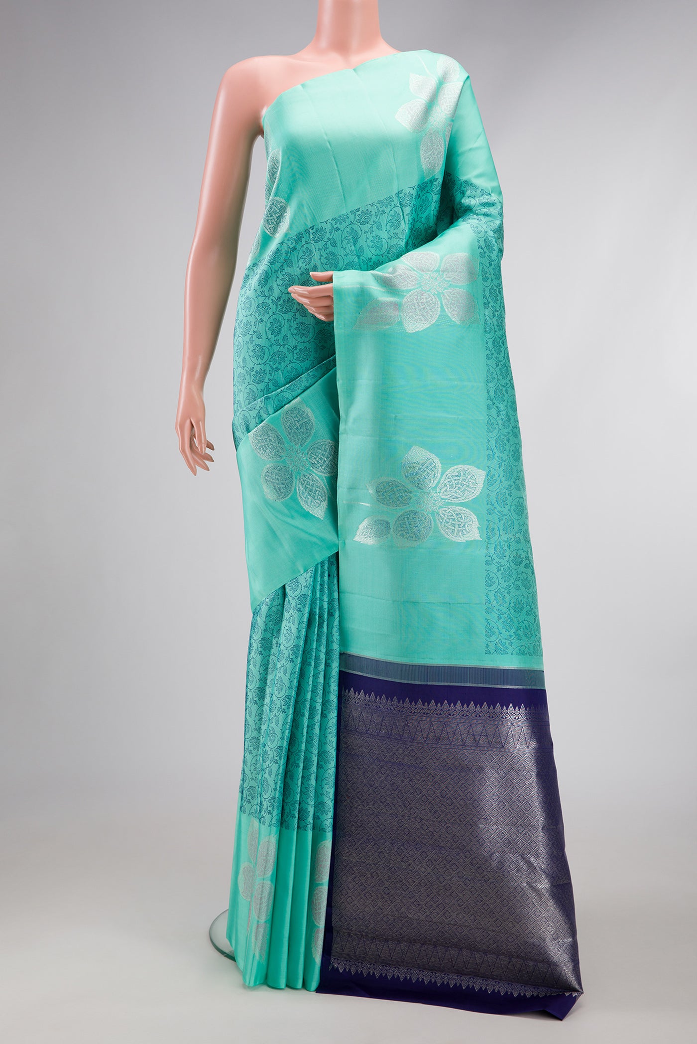 Sea Green Kanjivaram Silk Saree with Jacquard design on the body and Fancy Border.  displayed on a mannequin