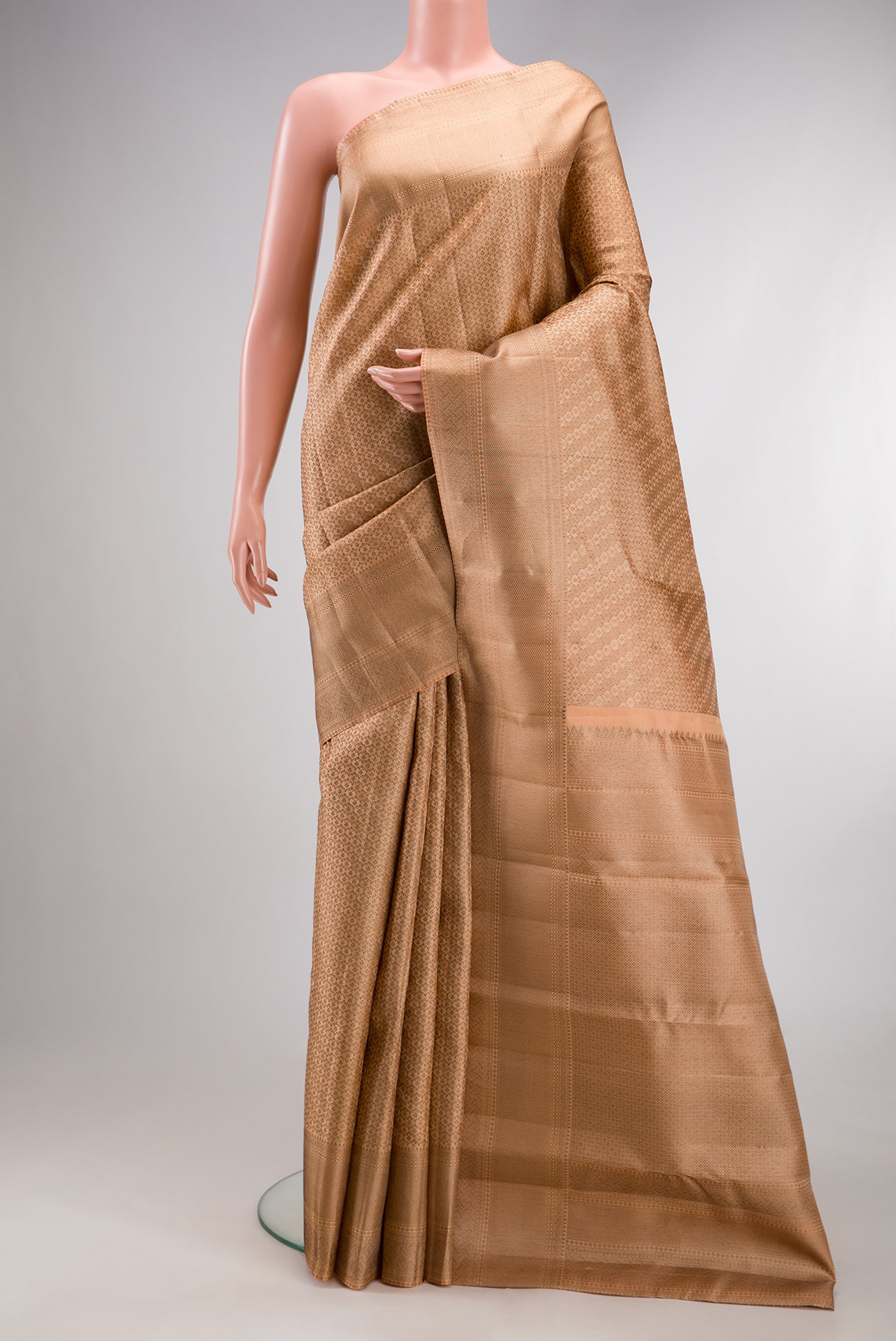 Peach Kanjivaram Silk Saree with Zari Brocade on the body and Zari Border.  displayed on a mannequin