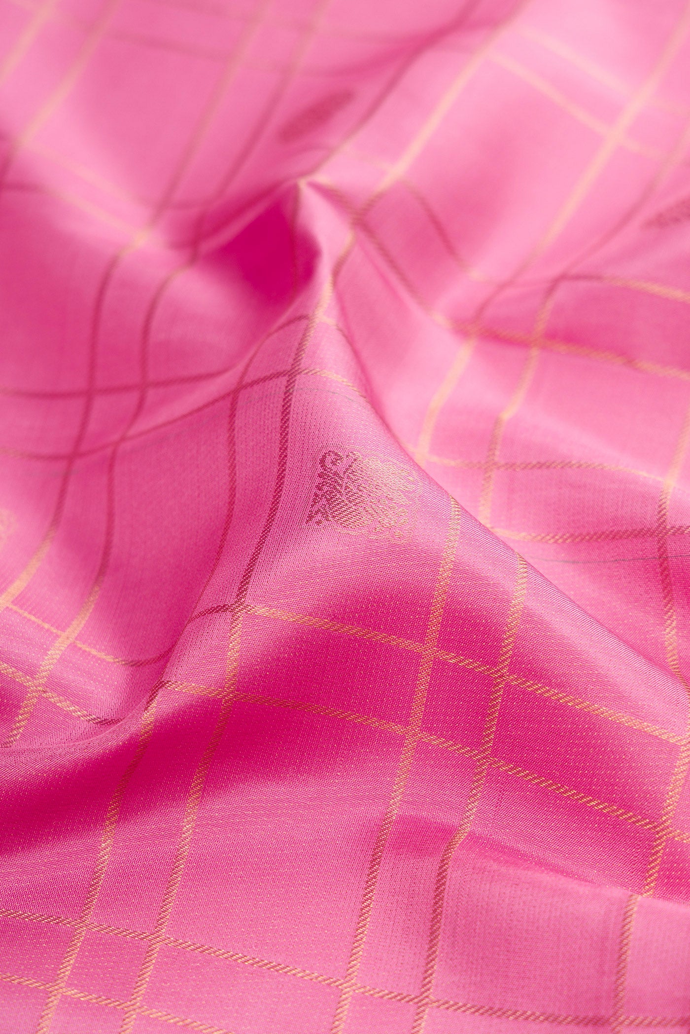 Close up of Rose pink Kanjivaram Silk Saree with Checked design on the body and Zari Border.  displaying folds