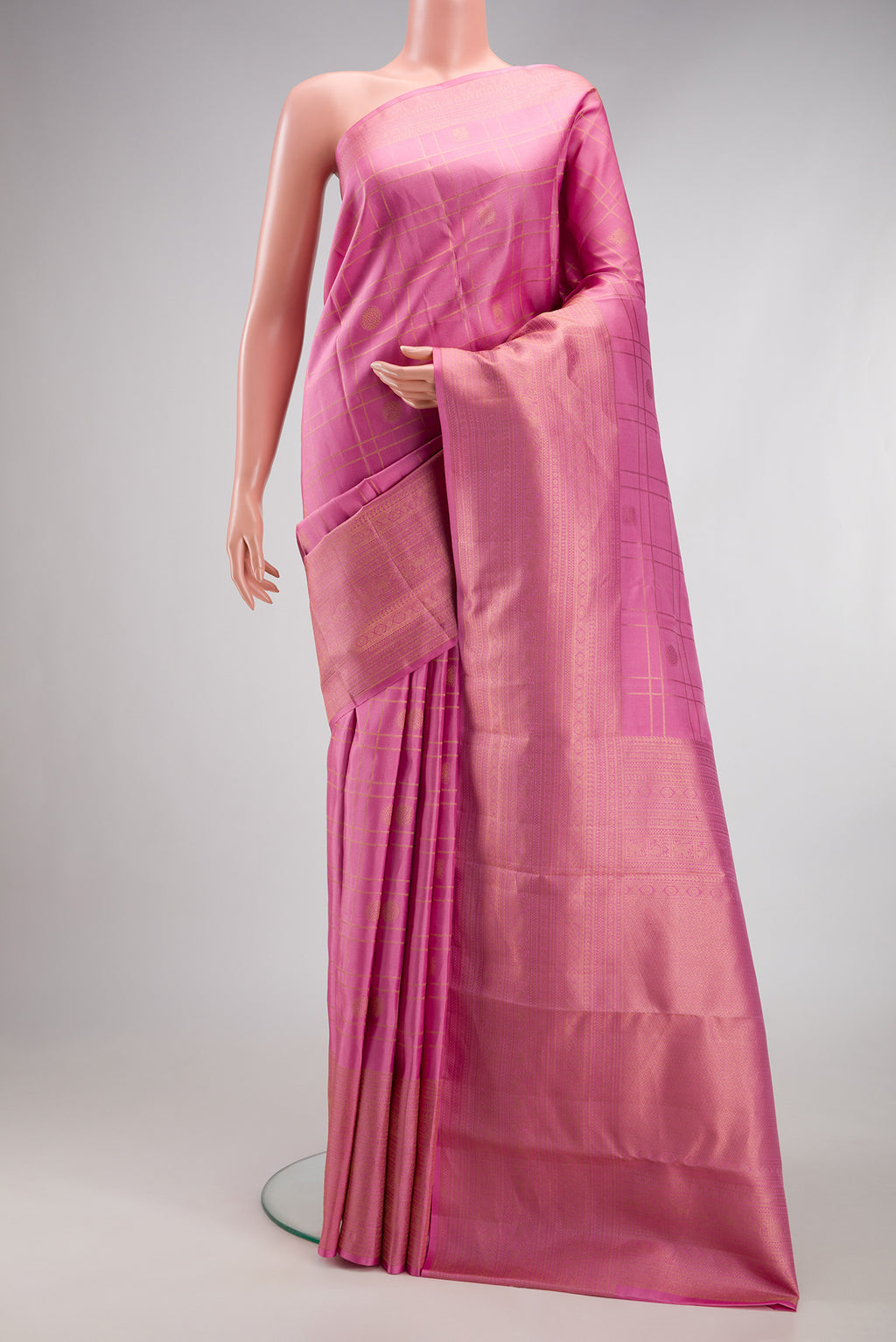 Rose pink Kanjivaram Silk Saree with Checked design on the body and Zari Border.  displayed on a mannequin