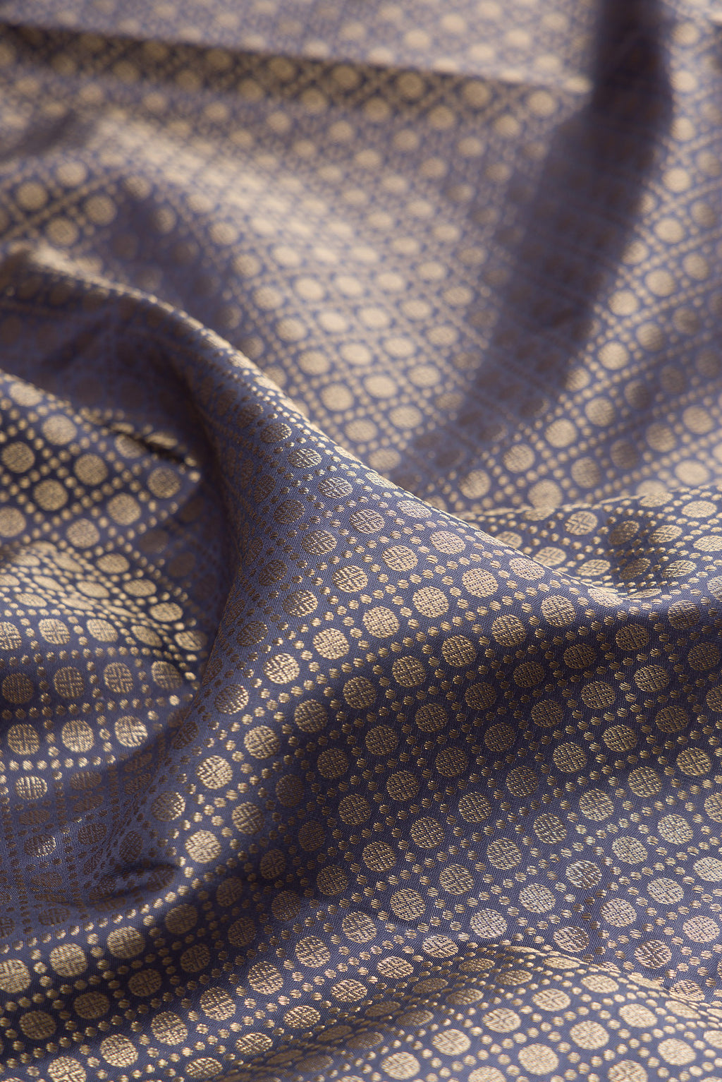 Close up of Pure Silk Grey Kanjivaram Saree with Zari Brocade on the body and Zari Border.  displaying folds