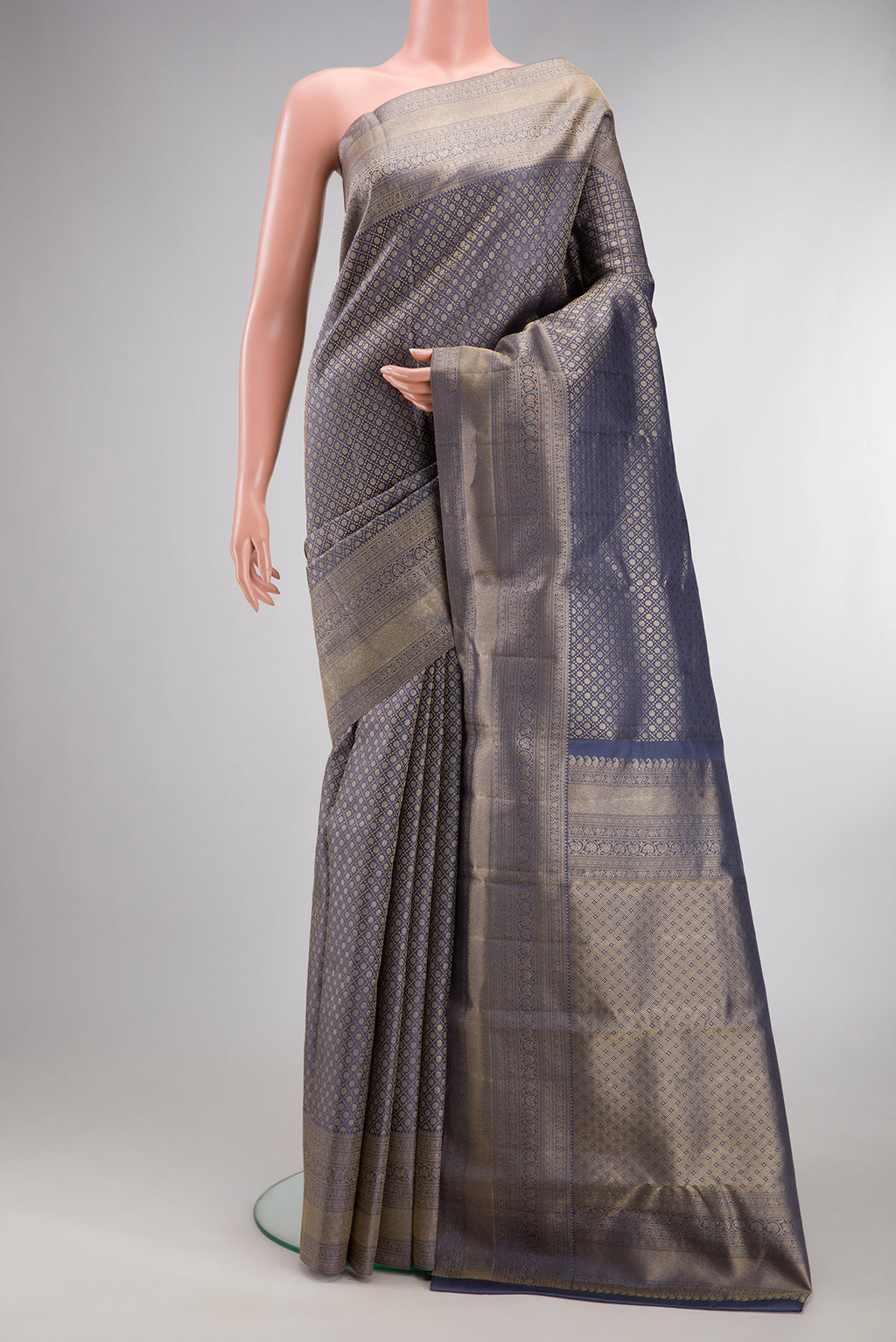 Pure Silk Grey Kanjivaram Saree with Zari Brocade on the body and Zari Border.  displayed on a mannequin