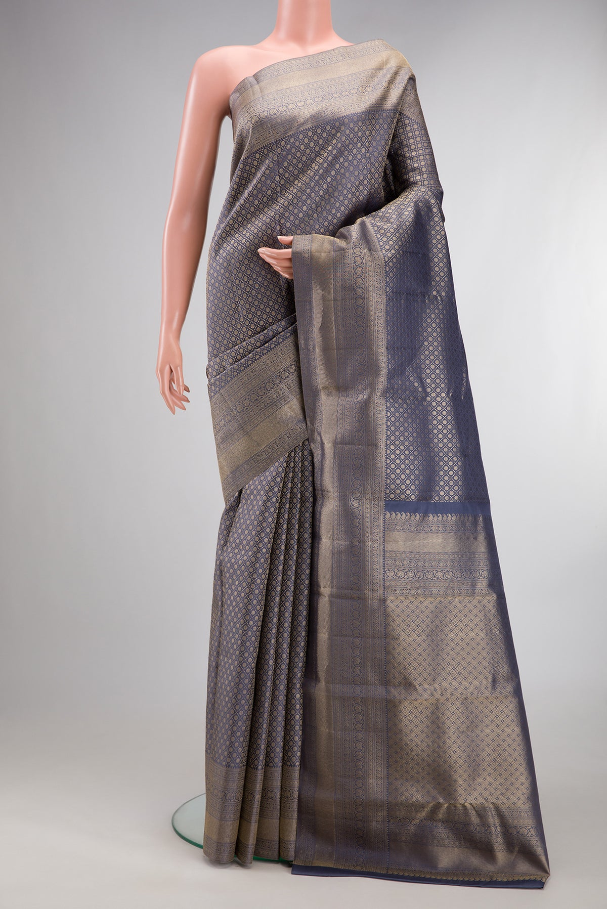 Pure Silk Grey Kanjivaram Saree with Zari Brocade on the body and Zari Border.  displayed on a mannequin