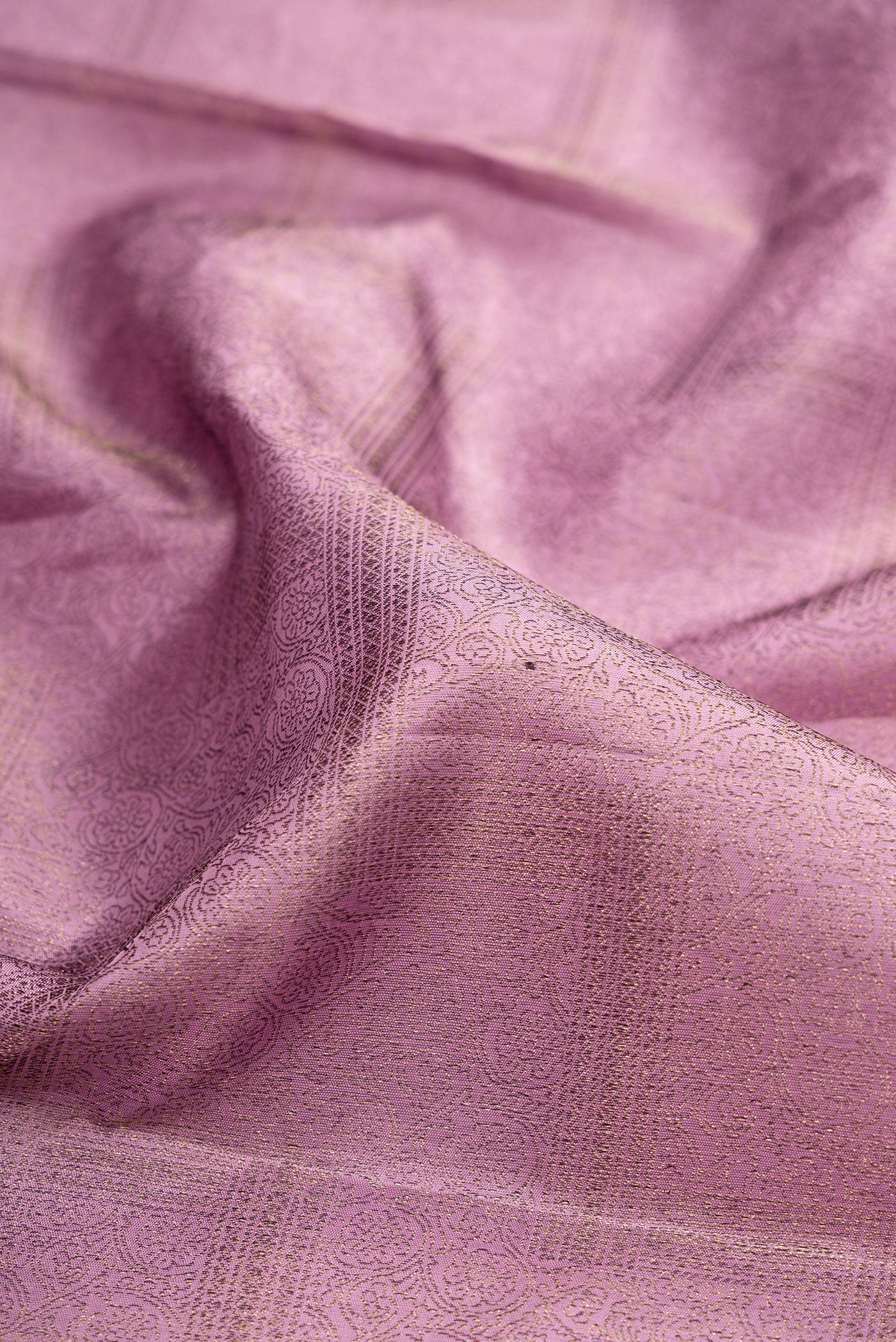 Close up of Lavender Kanjivaram Silk Saree with Zari Brocade on the body and Fancy Border.  displaying folds