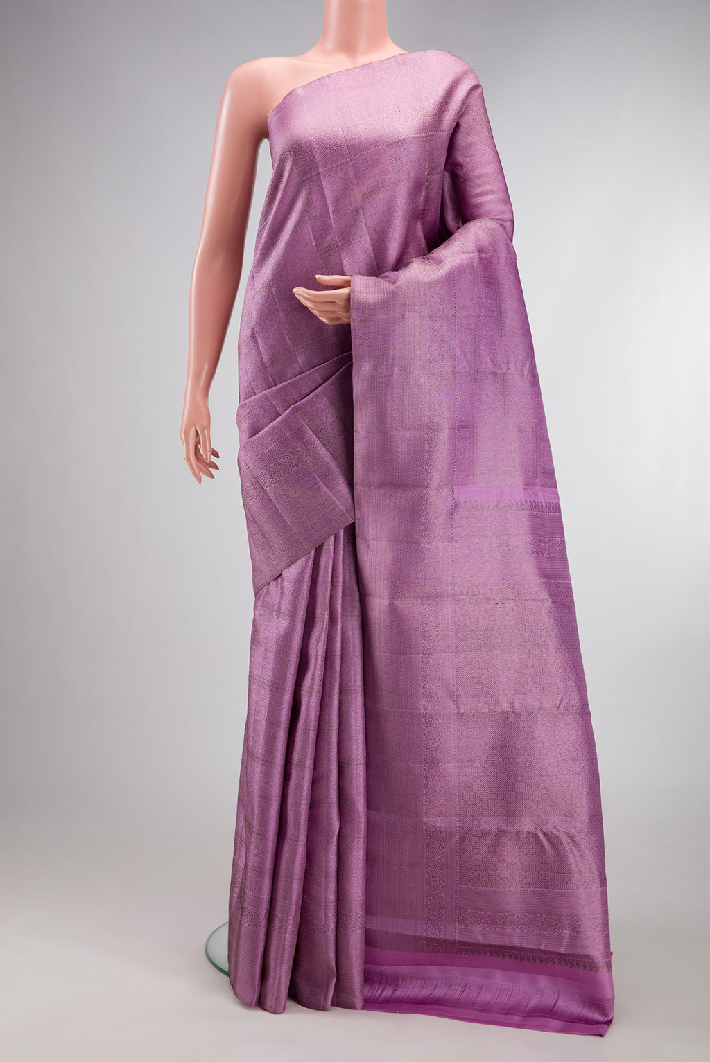 Lavender Kanjivaram Silk Saree with Zari Brocade on the body and Fancy Border.  displayed on a mannequin