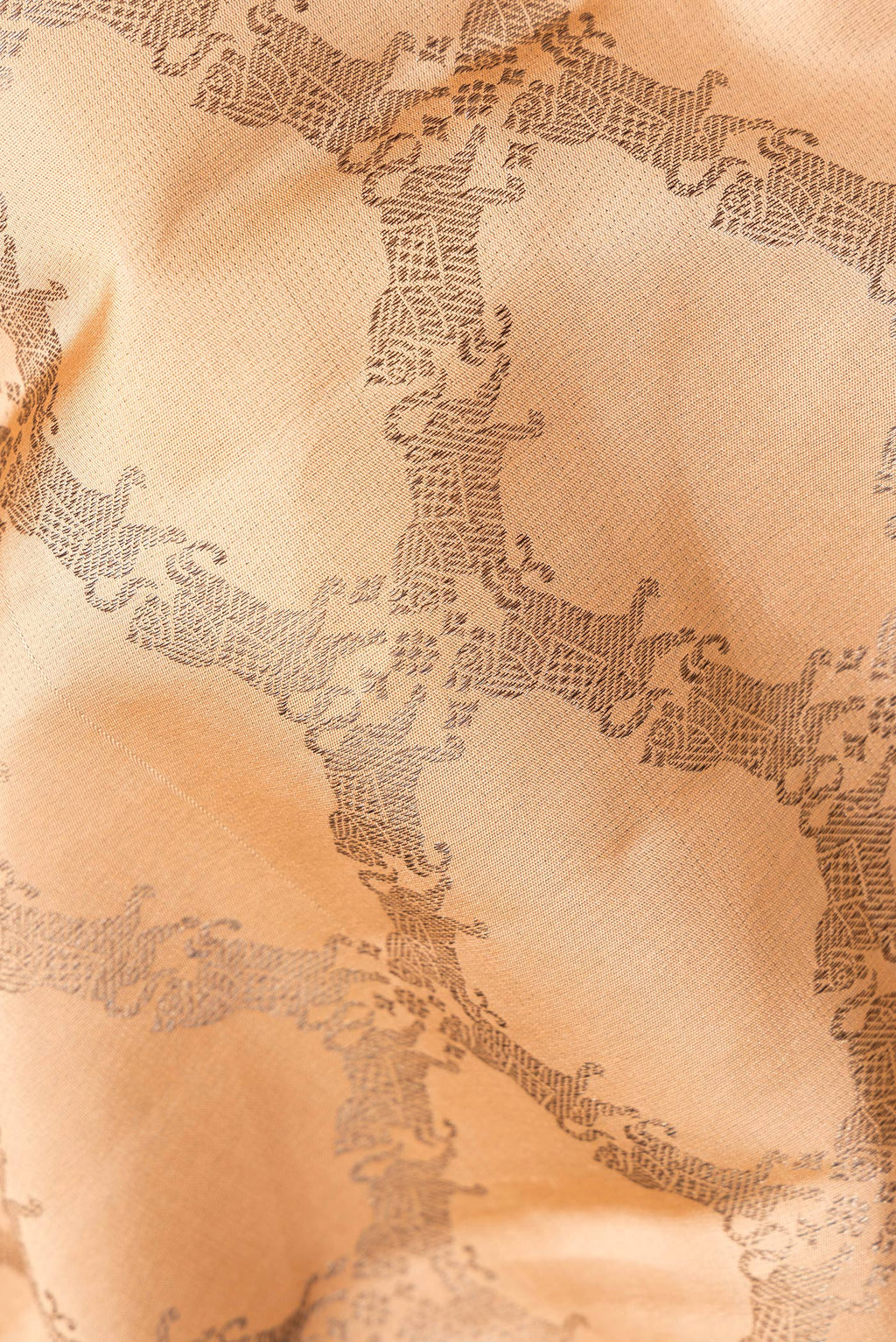 Close up of Pure Silk Golden Peach Dual Tone Kanjivaram Saree with Zari Brocade on the body and Fancy Border.  displaying folds