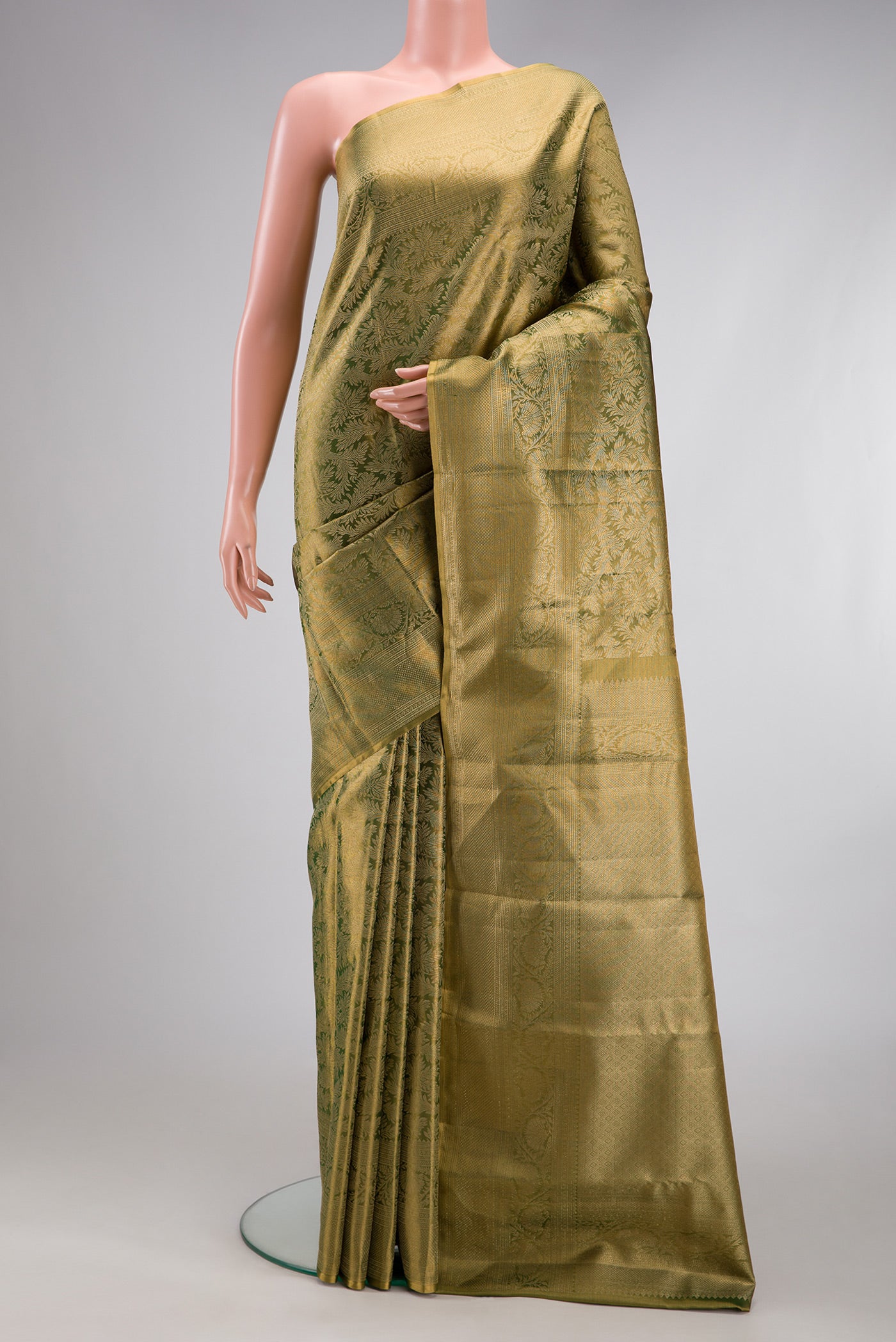 Green Dual Tone Kanjivaram Tissue Silk Saree with Zari Brocade on the body and Fancy Border.  displayed on a mannequin