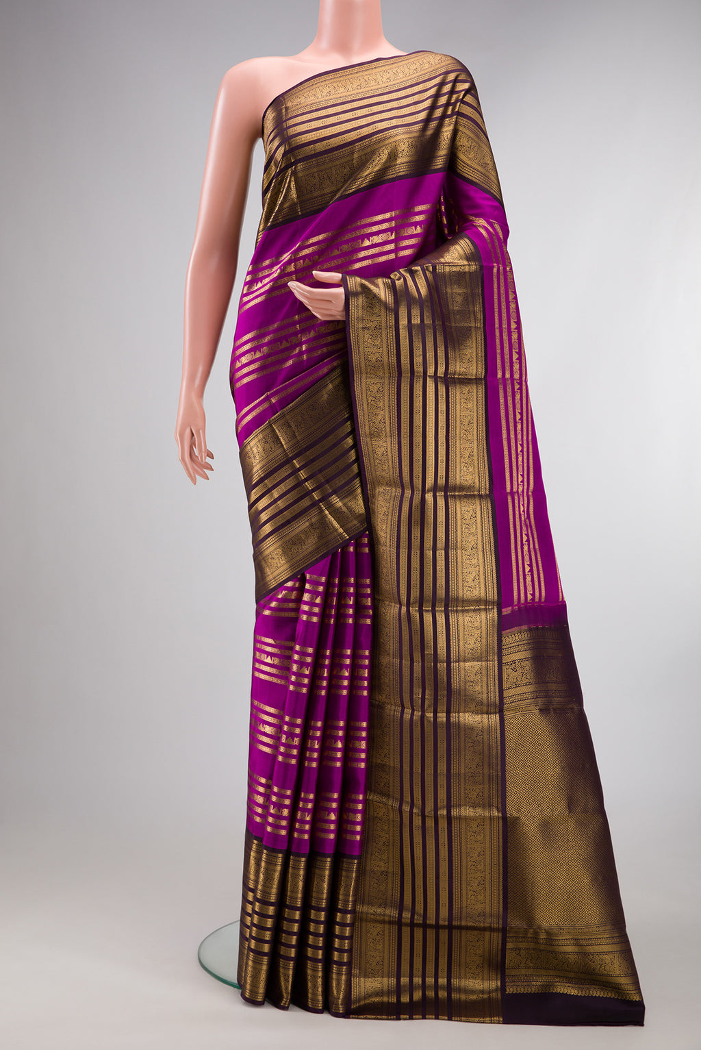 Pure Silk Magenta Kanjivaram Saree with Stripes on the body and Fancy Border.  displayed on a mannequin