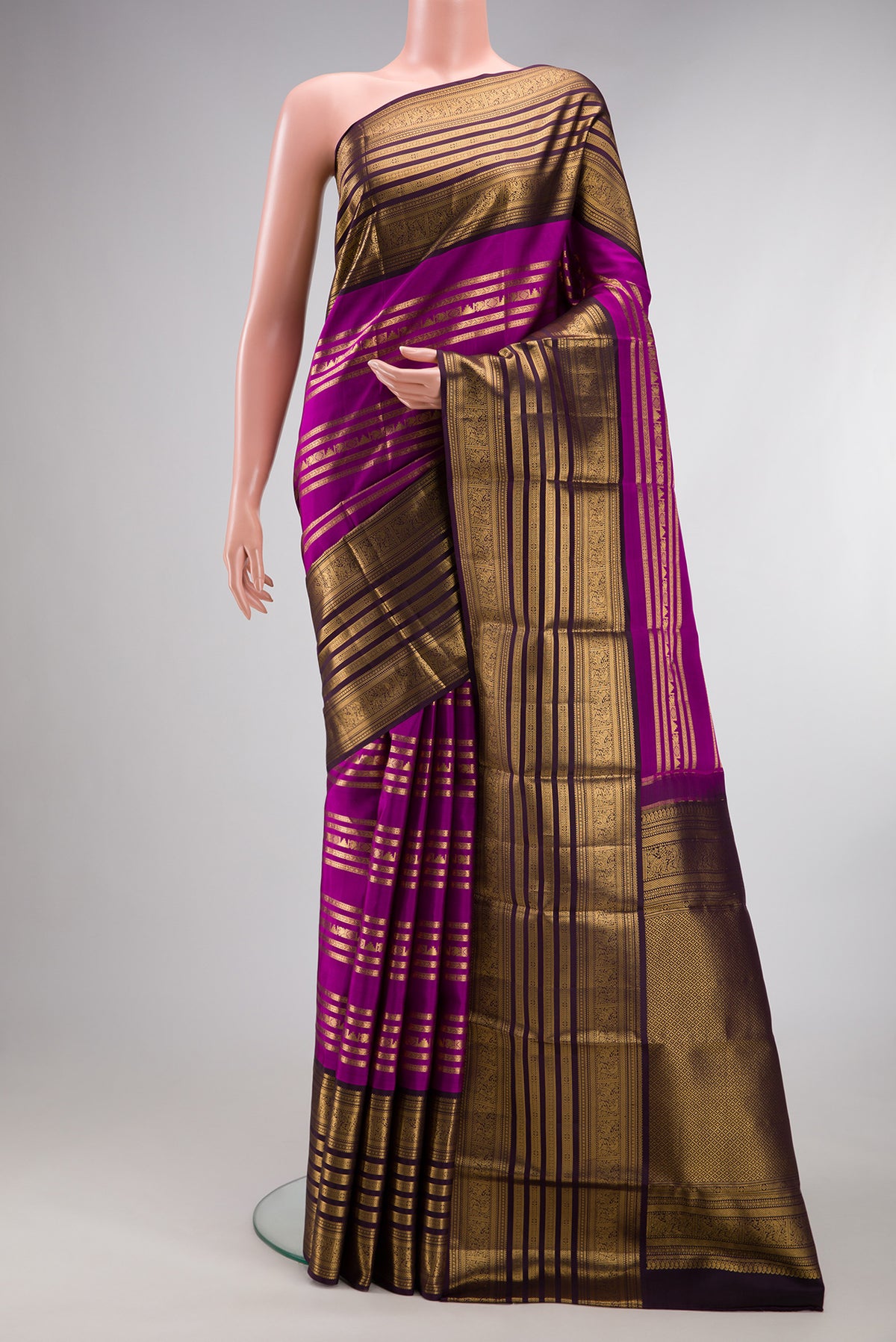 Pure Silk Magenta Kanjivaram Saree with Stripes on the body and Fancy Border.  displayed on a mannequin