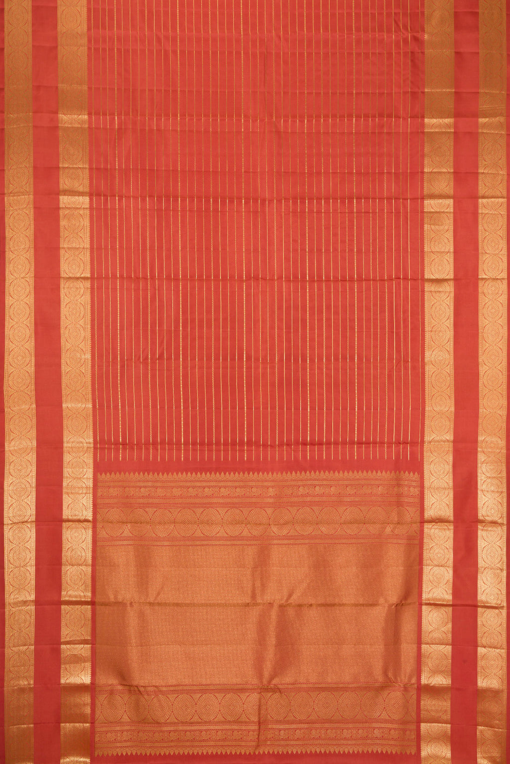 Flat view of Brick Orange Kanjivaram Silk Saree with Stripes on the body and Zari Border. 