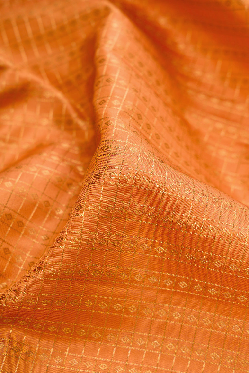 Close up of Sandal Kanjivaram Silk Saree with Checked design on the body and Zari Border.  displaying folds