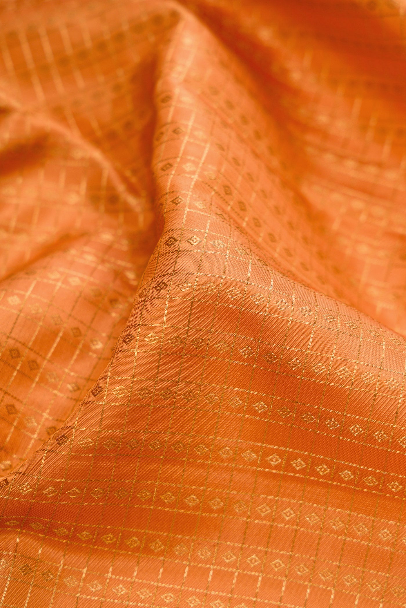 Close up of Sandal Kanjivaram Silk Saree with Checked design on the body and Zari Border.  displaying folds