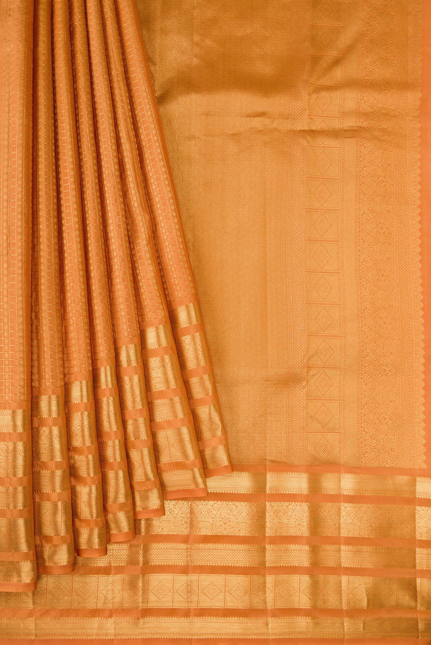 Pleats and pallu of Sandal Kanjivaram Silk Saree with Checked design on the body and Zari Border. 