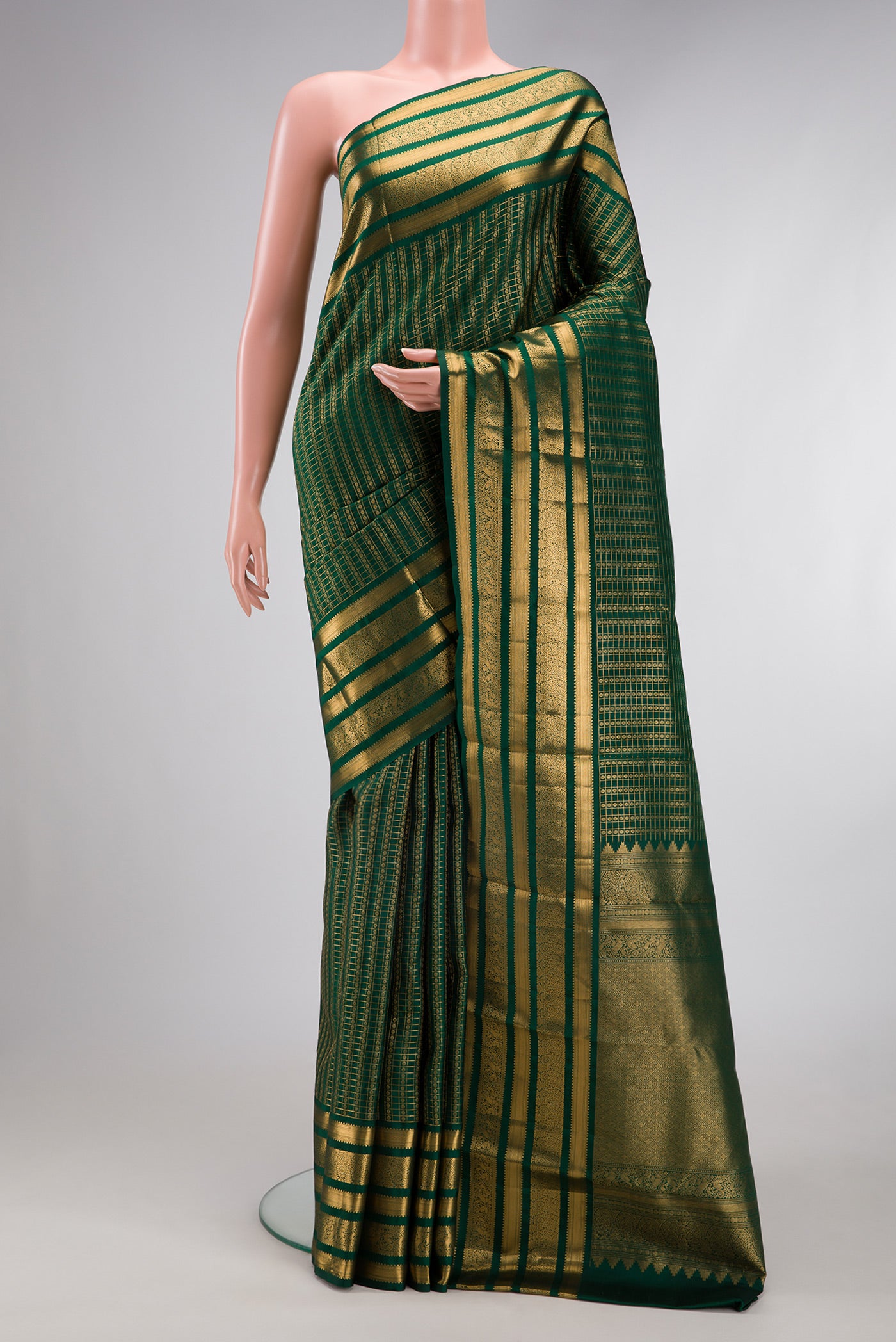 Bottle Green Kanjivaram Silk Saree with Checked design on the body and Zari Border.  displayed on a mannequin