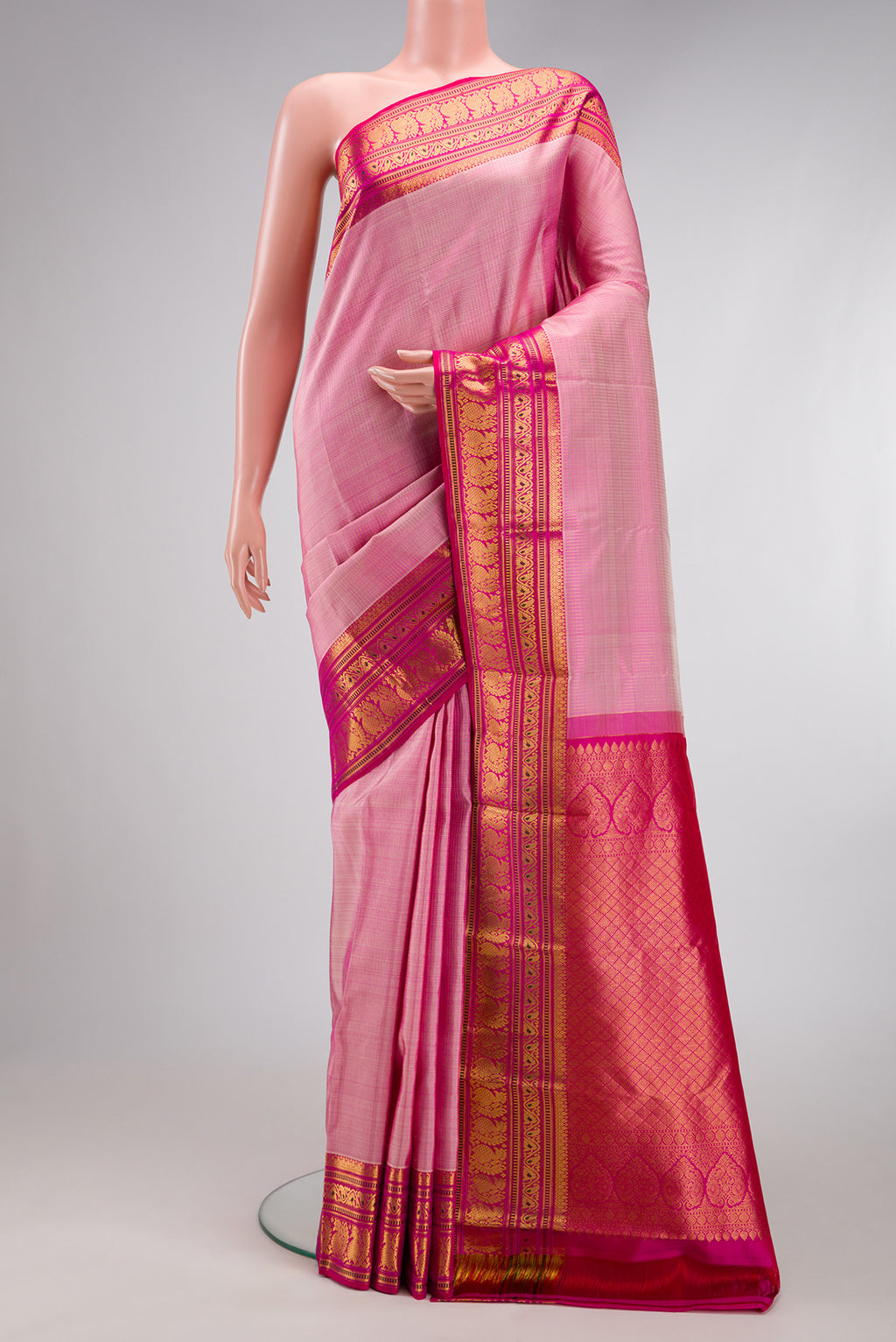 Rose pink Kanjivaram Silk Saree with Stripes on the body and Zari Border.  displayed on a mannequin