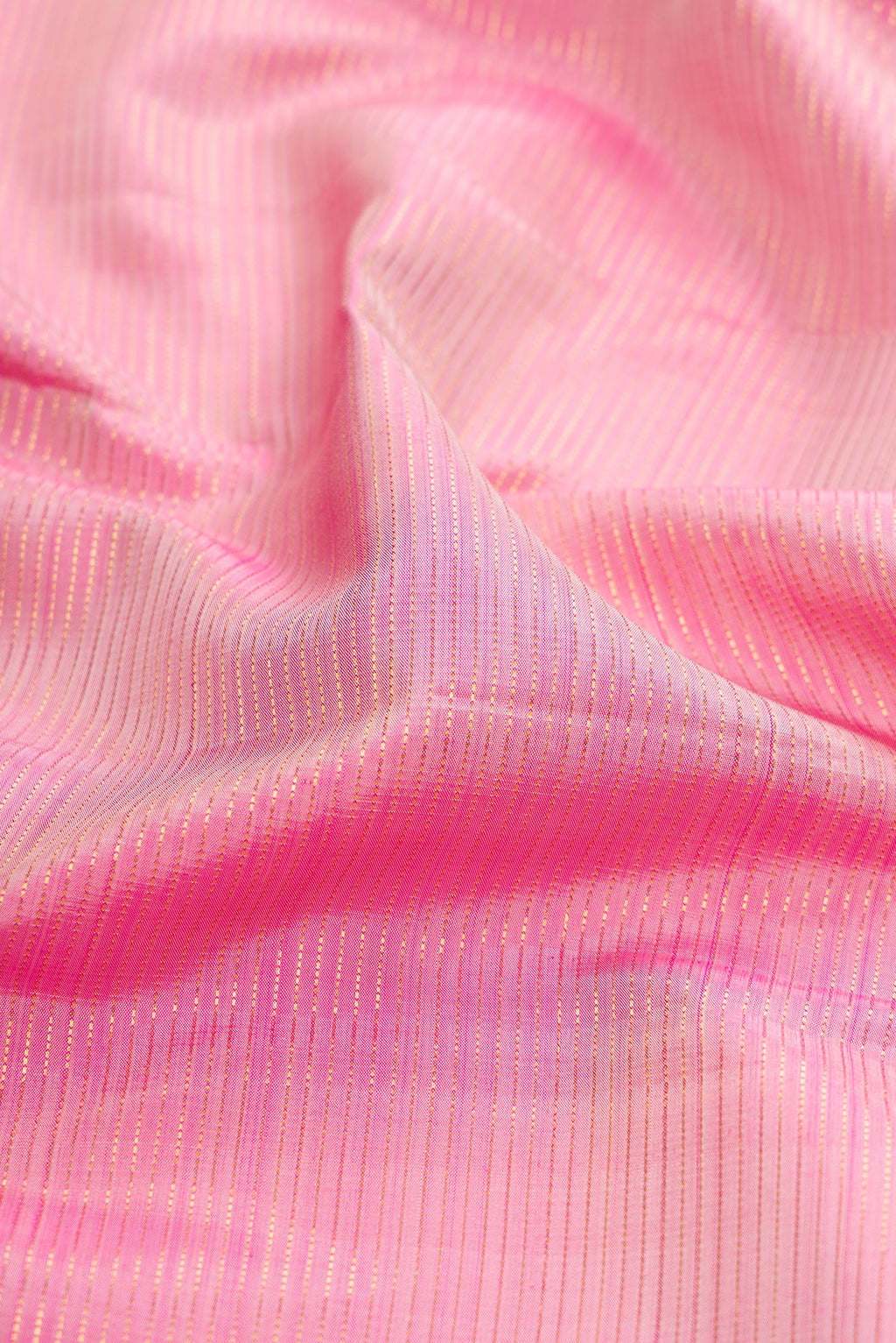 Close up of Rose pink Kanjivaram Silk Saree with Stripes on the body and Zari Border.  displaying folds