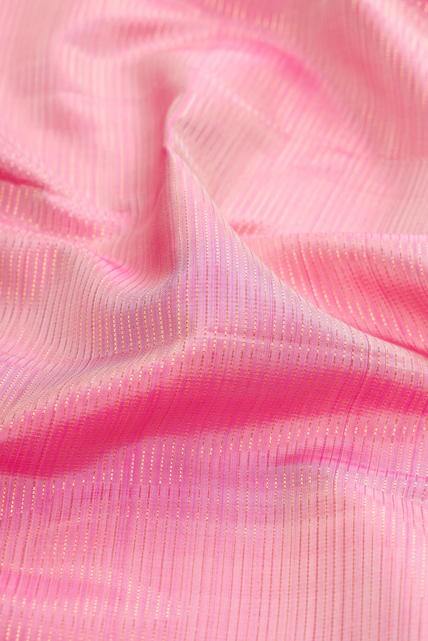 Close up of Rose pink Kanjivaram Silk Saree with Stripes on the body and Zari Border.  displaying folds