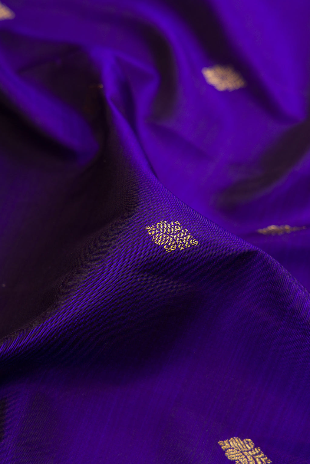 Close up of Violet Kanjivaram Silk Saree with Zari Butta on the body and Zari Border.  displaying folds