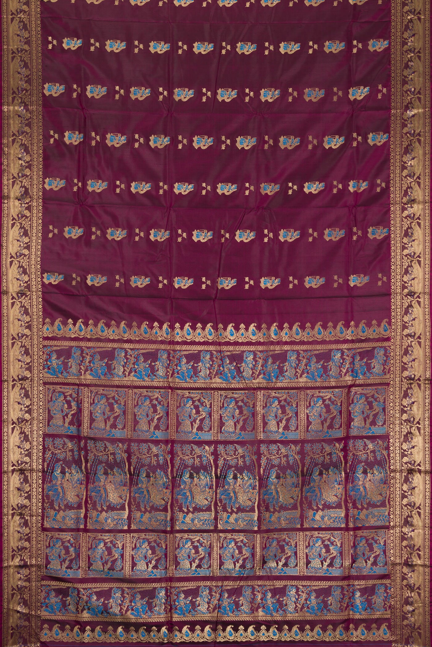 Flat view of Burgundy Baluchari Silk Saree with Zari And Thread Butta on the body and Fancy Border. 