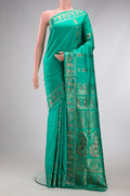 Sea Green Dual Tone Baluchari Silk Saree with Zari And Thread Butta on the body and Fancy Border.  displayed on a mannequin