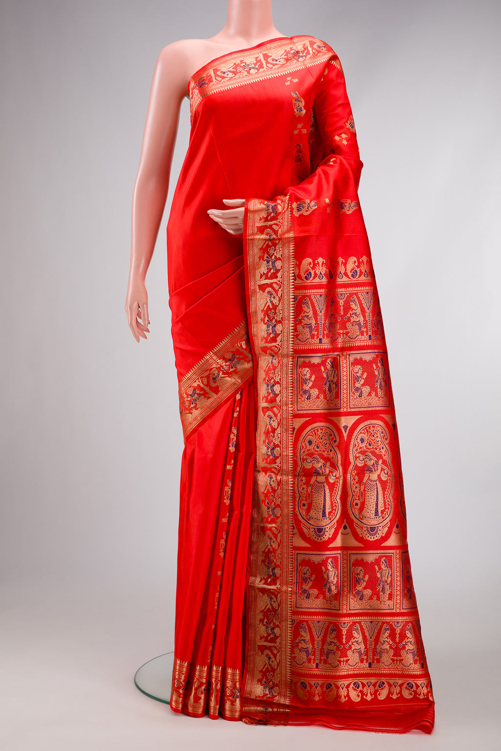 Orange Baluchari Silk Saree with Zari And Thread Butta on the body and Fancy Border.  displayed on a mannequin