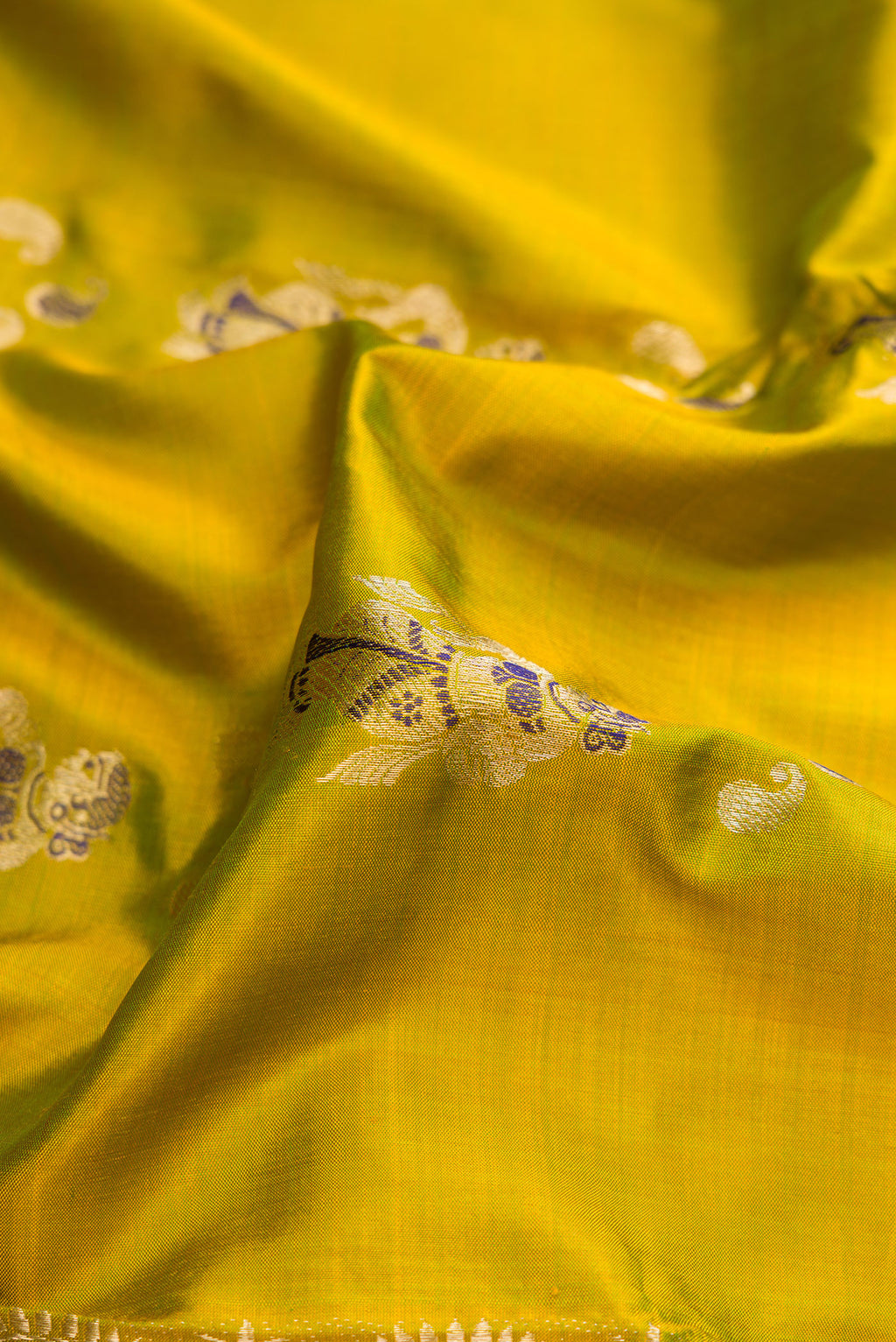 Close up of Mehandi Green Dual Tone Baluchari Silk Saree with Zari And Thread Butta on the body and Zari And Thread Border.  displaying folds