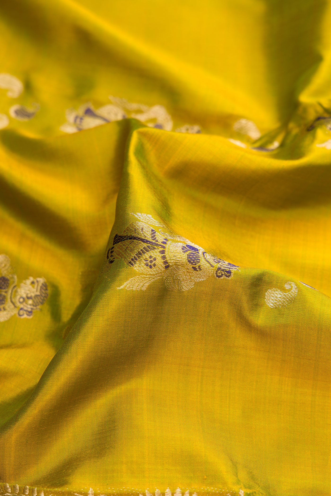 Close up of Mehandi Green Dual Tone Baluchari Silk Saree with Zari And Thread Butta on the body and Zari And Thread Border.  displaying folds