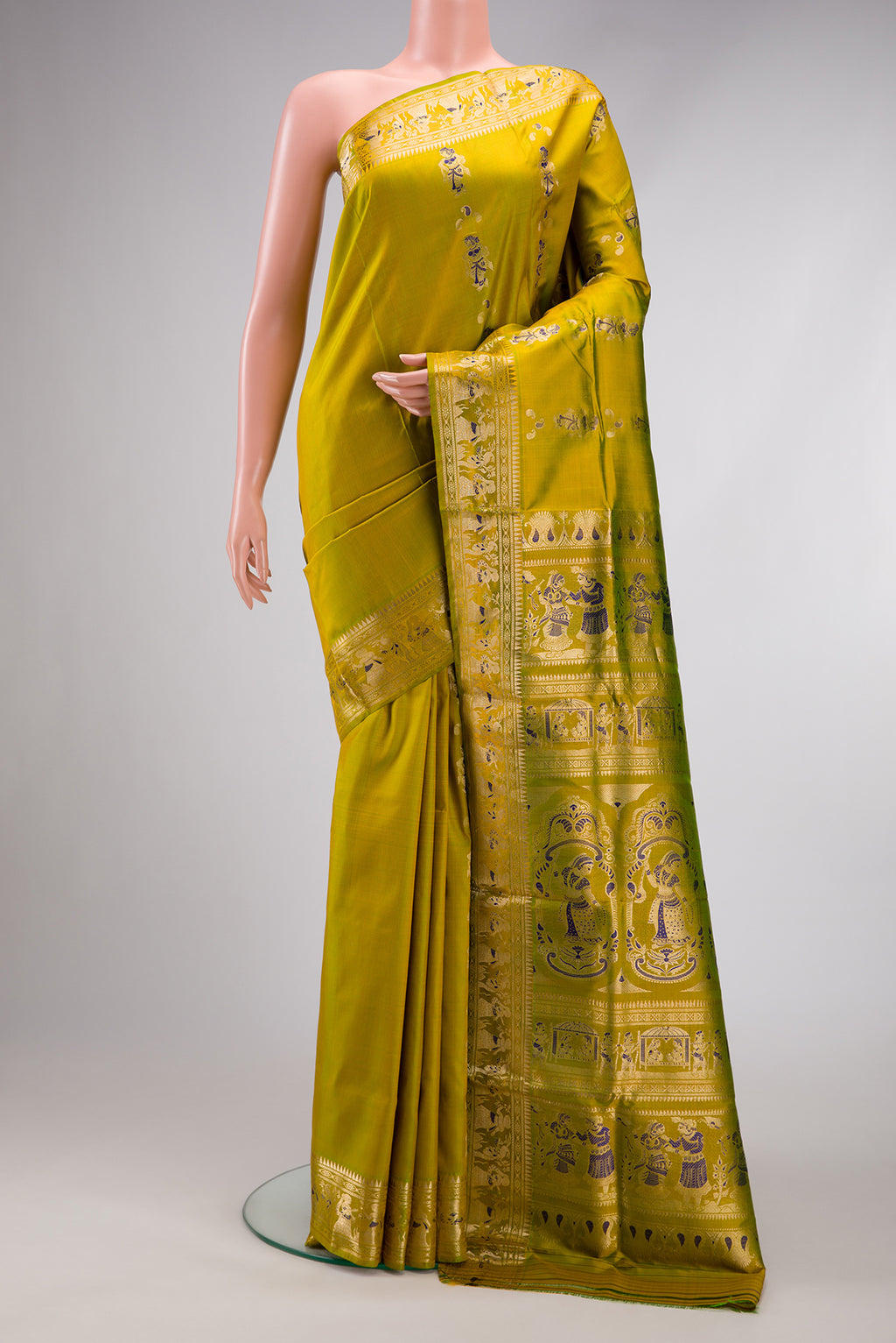 Mehandi Green Dual Tone Baluchari Silk Saree with Zari And Thread Butta on the body and Zari And Thread Border.  displayed on a mannequin
