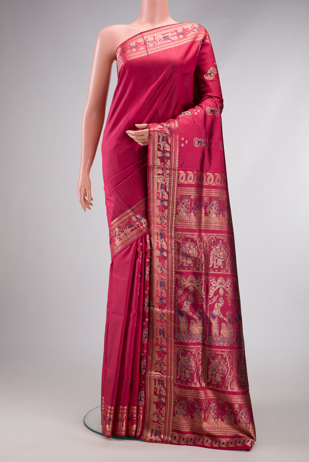 Maroon Baluchari Silk Saree with Zari And Thread Butta on the body and Zari Border.  displayed on a mannequin