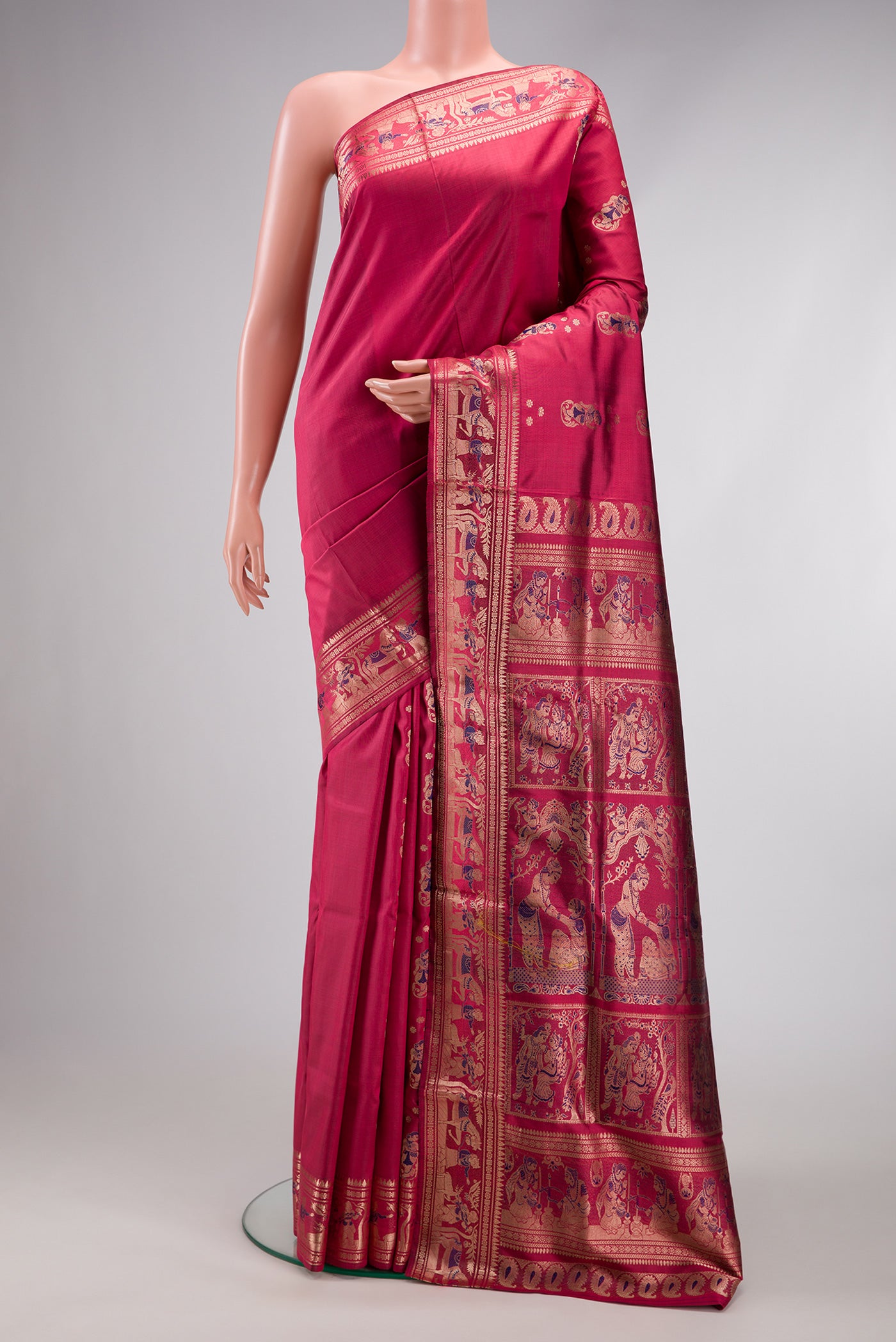 Maroon Baluchari Silk Saree with Zari And Thread Butta on the body and Zari Border.  displayed on a mannequin