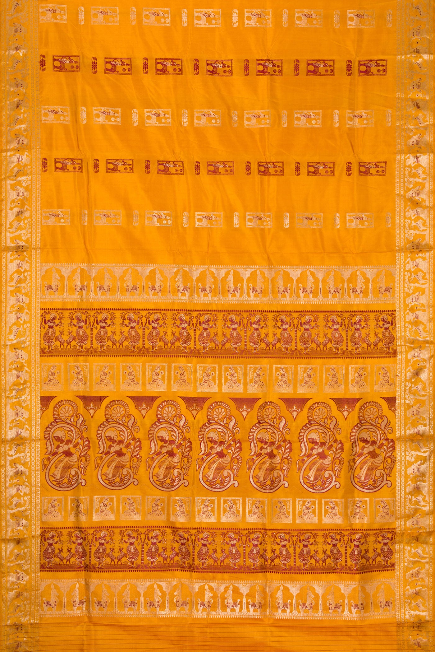 Flat view of Mustard Baluchari Silk Saree with Zari And Thread Butta on the body and Zari Border. 