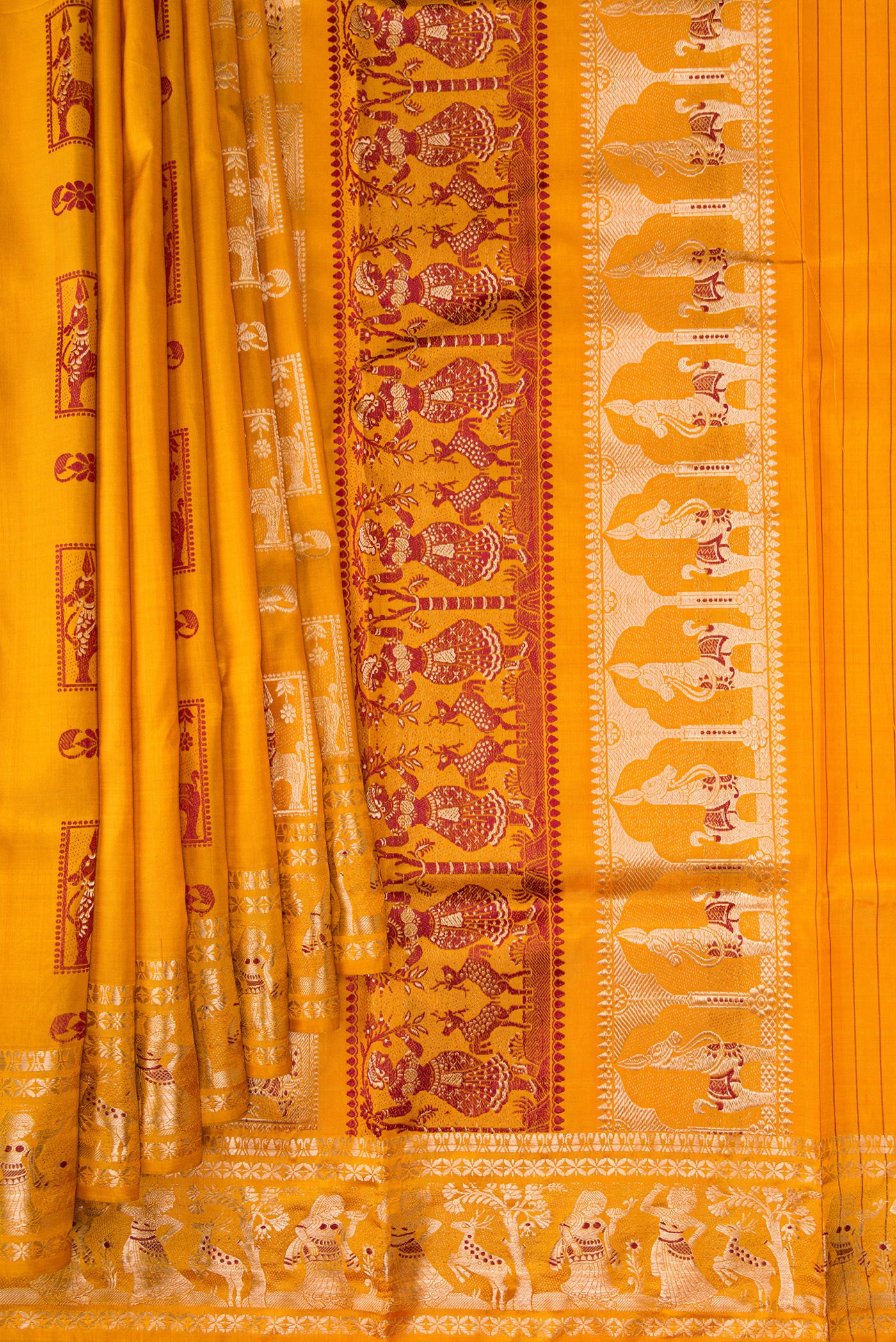 Pleats and pallu of Mustard Baluchari Silk Saree with Zari And Thread Butta on the body and Zari Border. 